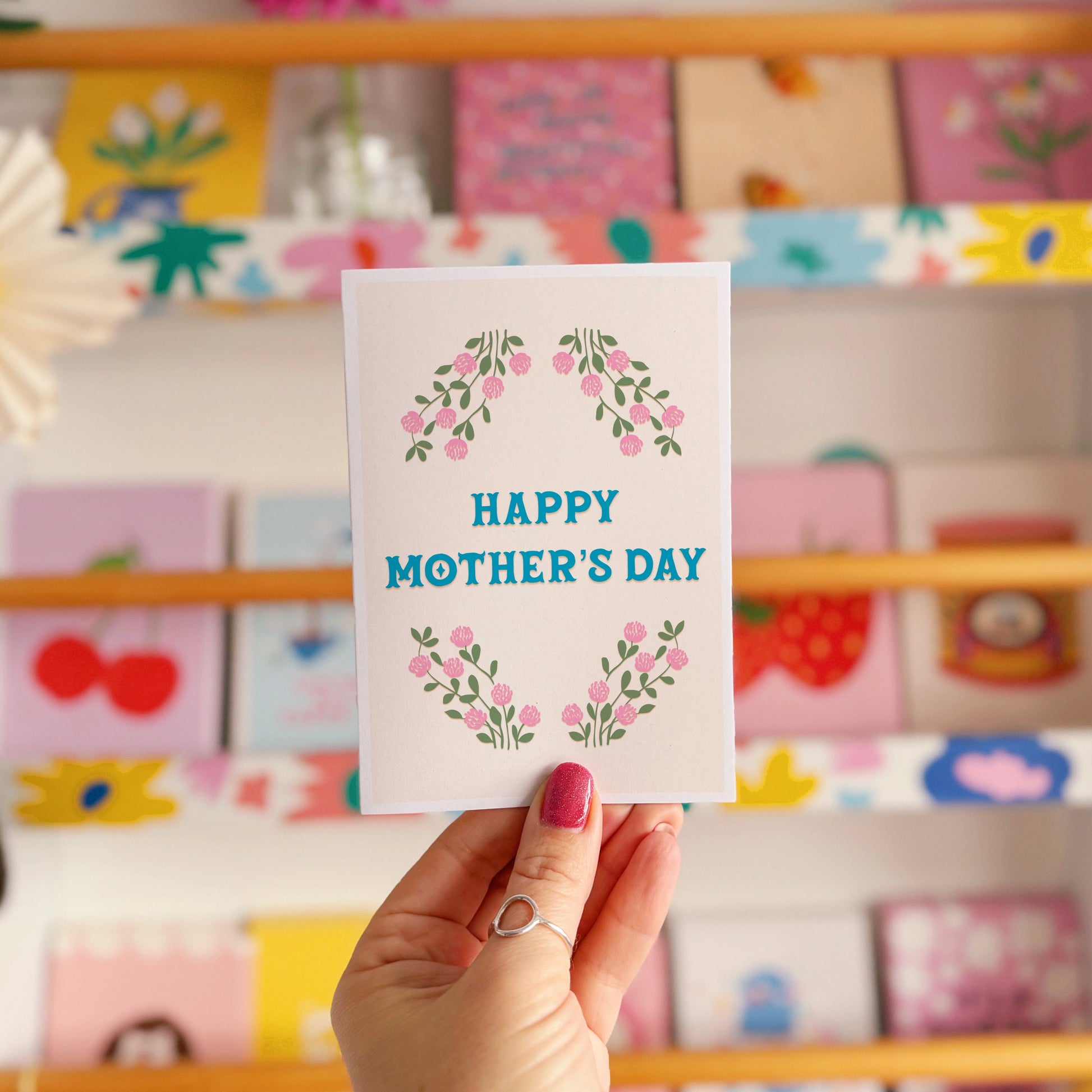A floral card with the message 'Happy Mother's Day' on the front.