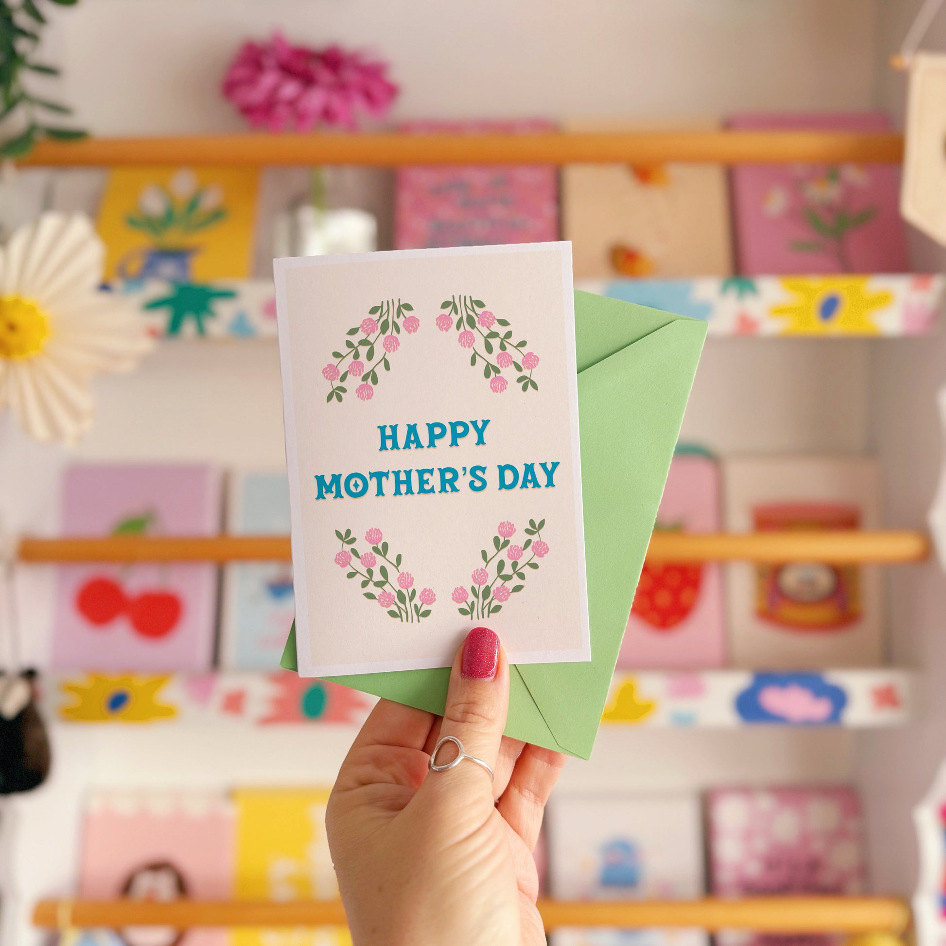 A floral card with the message 'Happy Mother's Day' on the front.