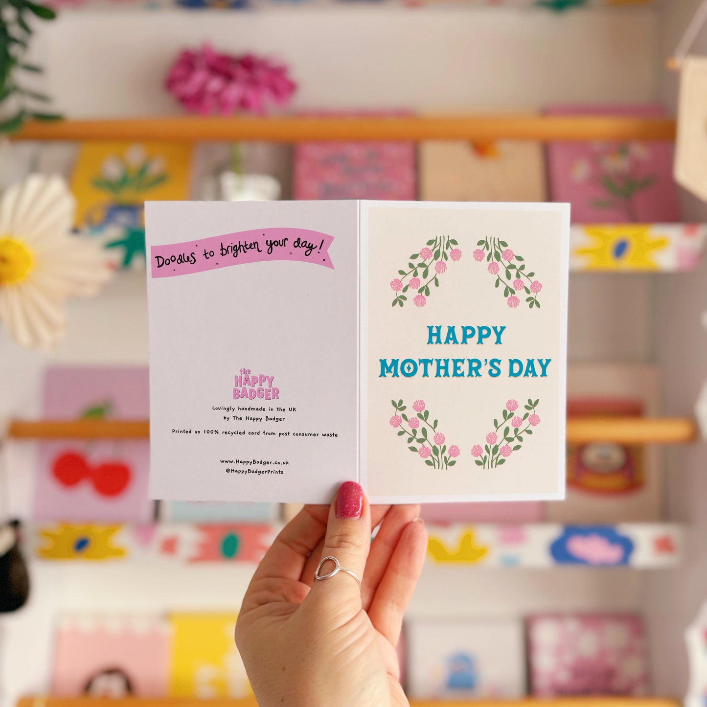A floral card with the message 'Happy Mother's Day' on the front.