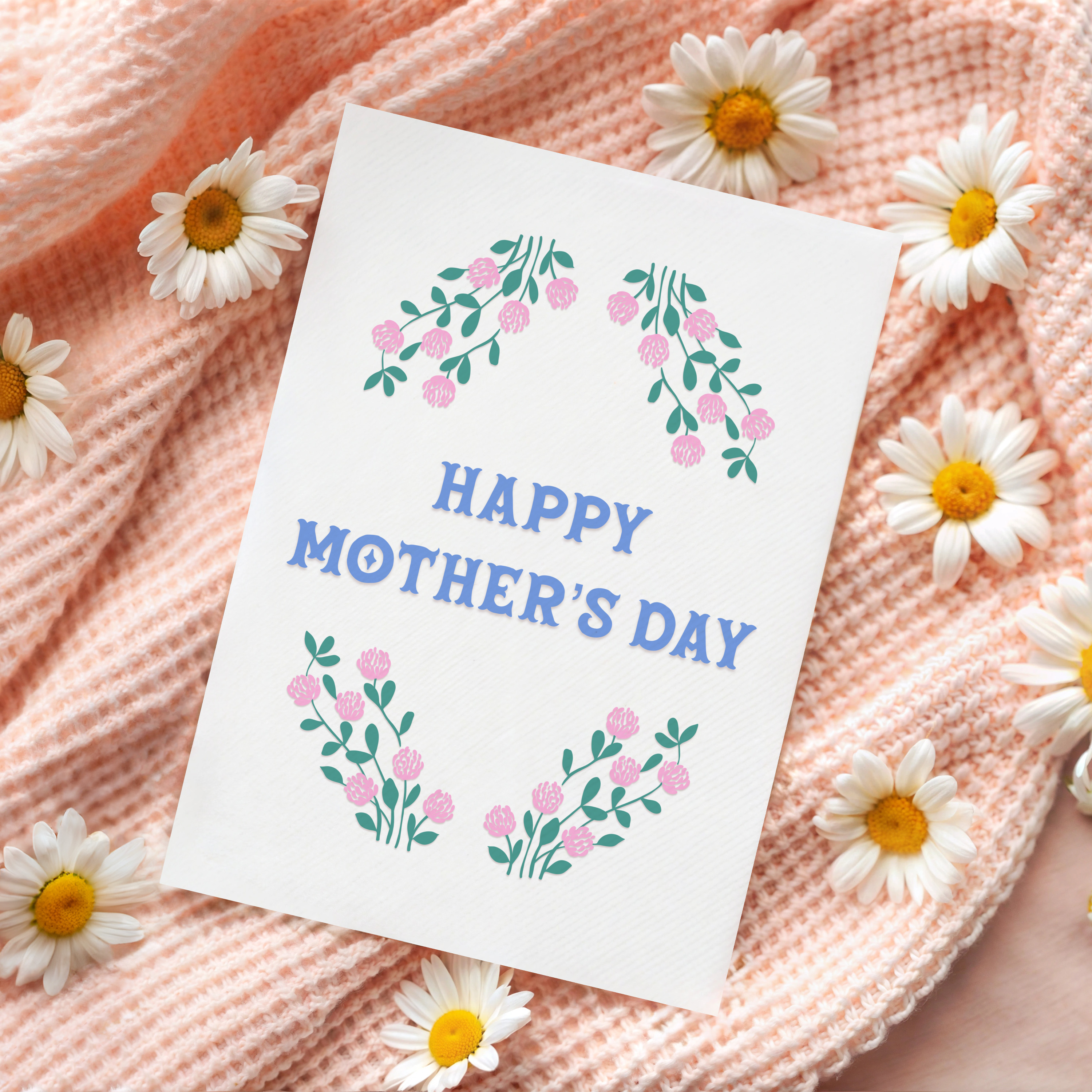 A Mother's Day card, with a pink and green floral border and the words 'Happy Mother's Day' written in the centre in blue.