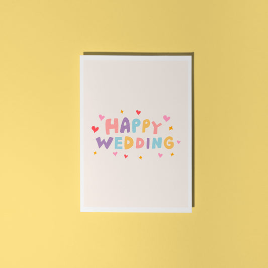 A minimalistic card with colourful hand lettering that reads 'Happy Wedding' with little heart and star doodles around it.