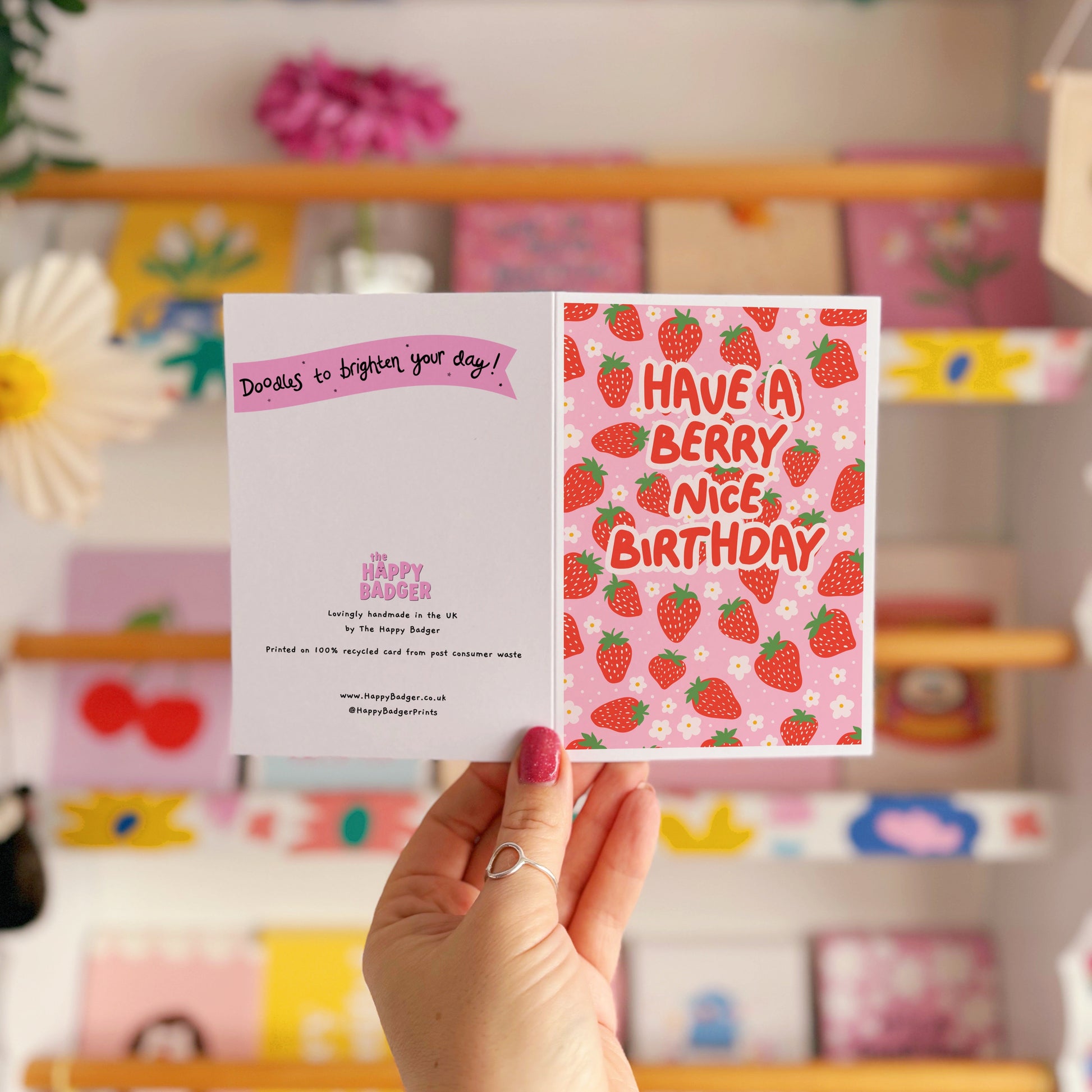 A card with a strawberry pattern, and text that reads 'have a berry nice birthday' in red.