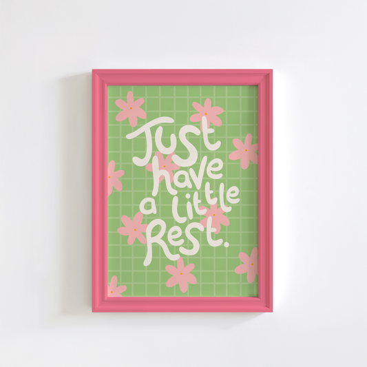 Framed artwork with 'Just have a little rest' text and pink flowers on a green grid background.