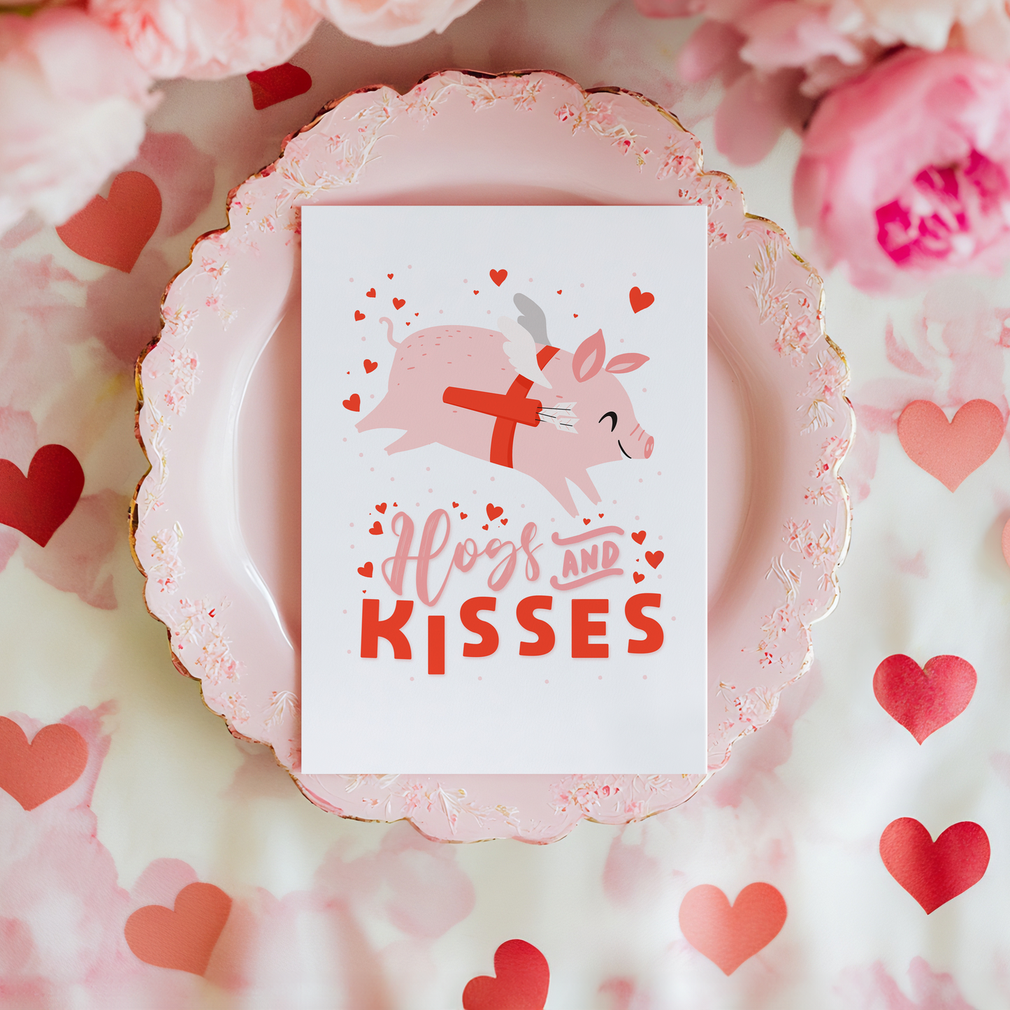 A love themed card, with a flying pig dressed as cupid and the words 'Hogs and kisses' underneath.