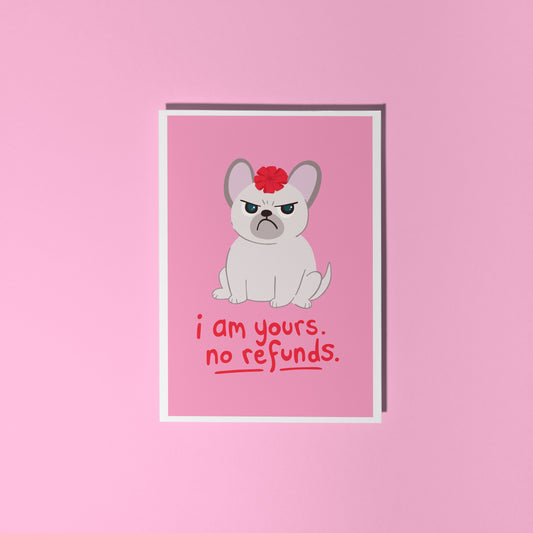 A pink greetings card with an illustration of a grumpy dog with a bow on it's head, and text underneath that reads 'I am yours, no refunds.'