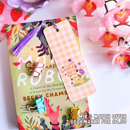 A yellow gingham bookmark with an illustration of a little duck with purple flowers. The text on the bookmark reads 'I just wanna dilly dally'.