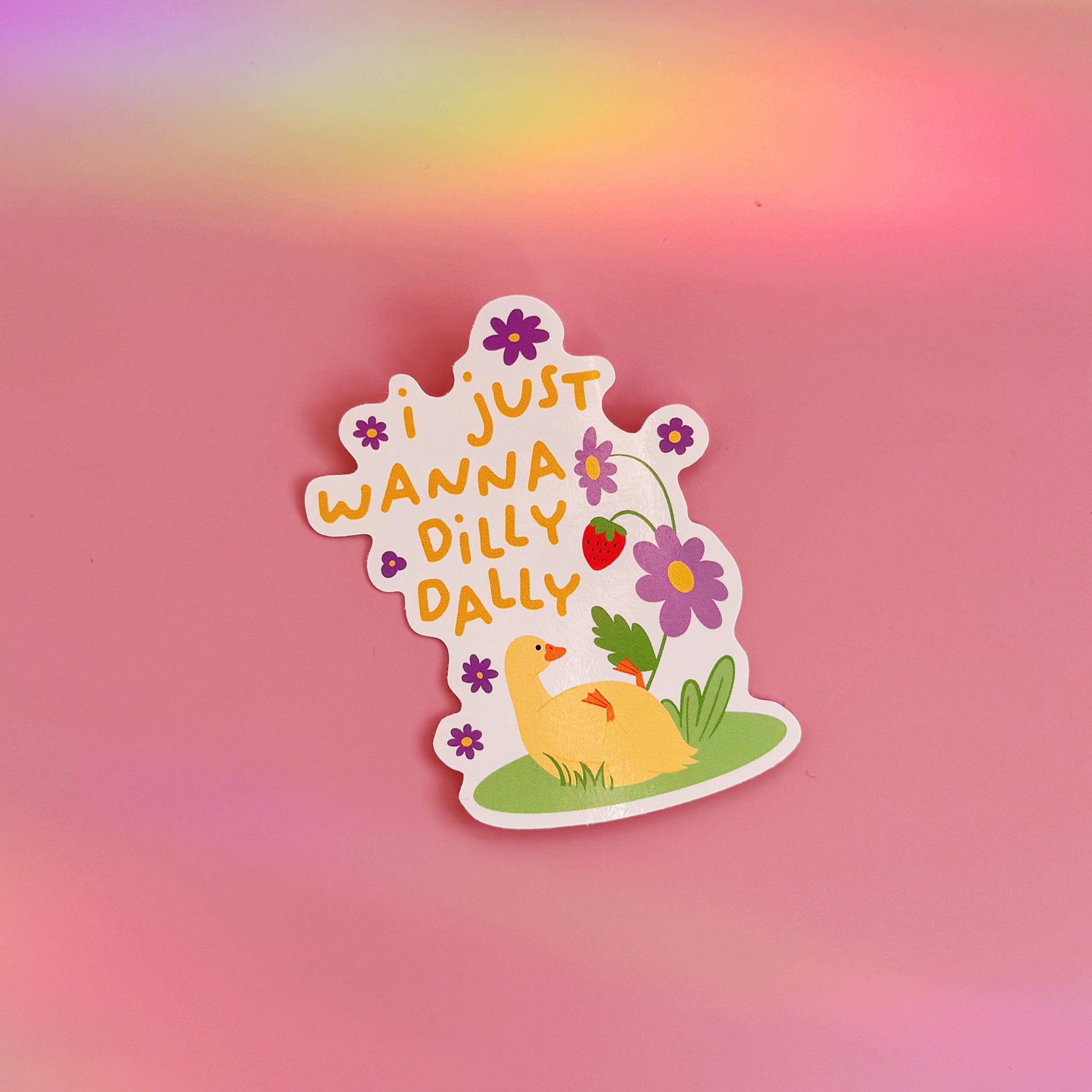 A waterproof vinyl sticker with a duck lazing amongst flowers, with text that reads 'I just wanna dilly dally'.
