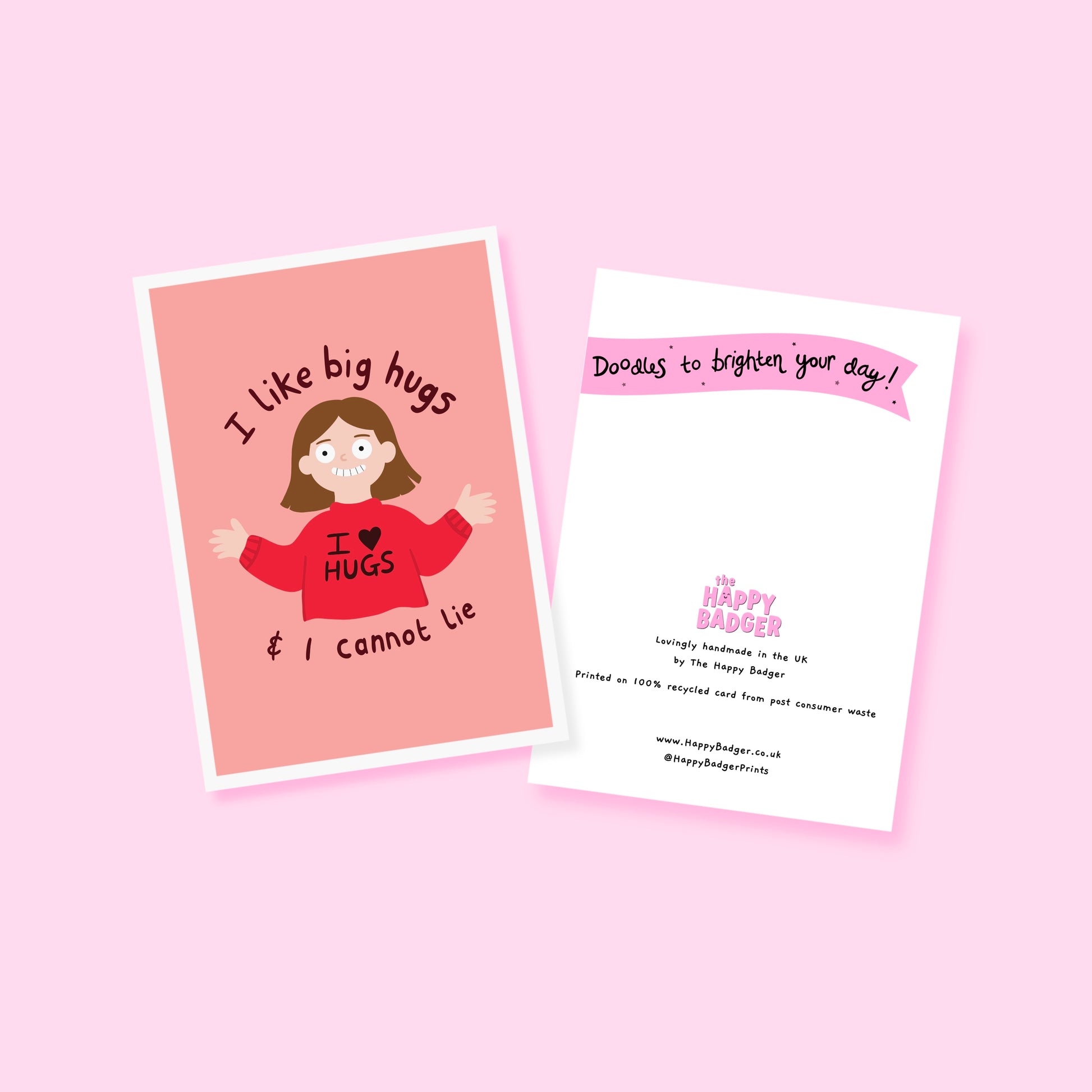 A pinkish red card with an illustration of a slightly creepy looking woman wearing a red jumper that says 'I love hugs' and text around her saying 'I like big hugs and I cannot lie'.