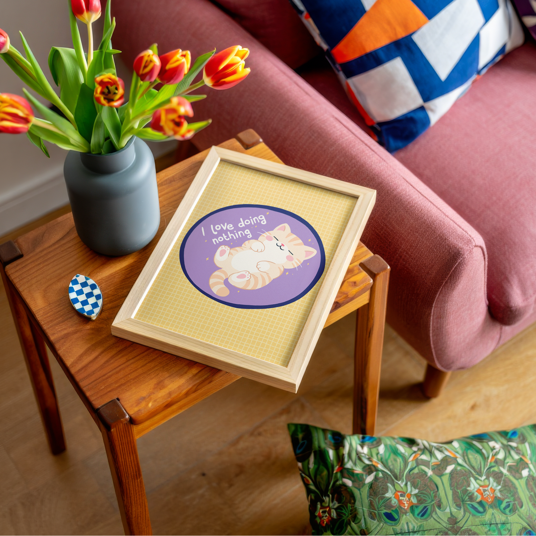 A yellow and purple print, with an illustration of a ginger cat laying on its back. Next to the cat is a quote that reads 'I love doing nothing'.
