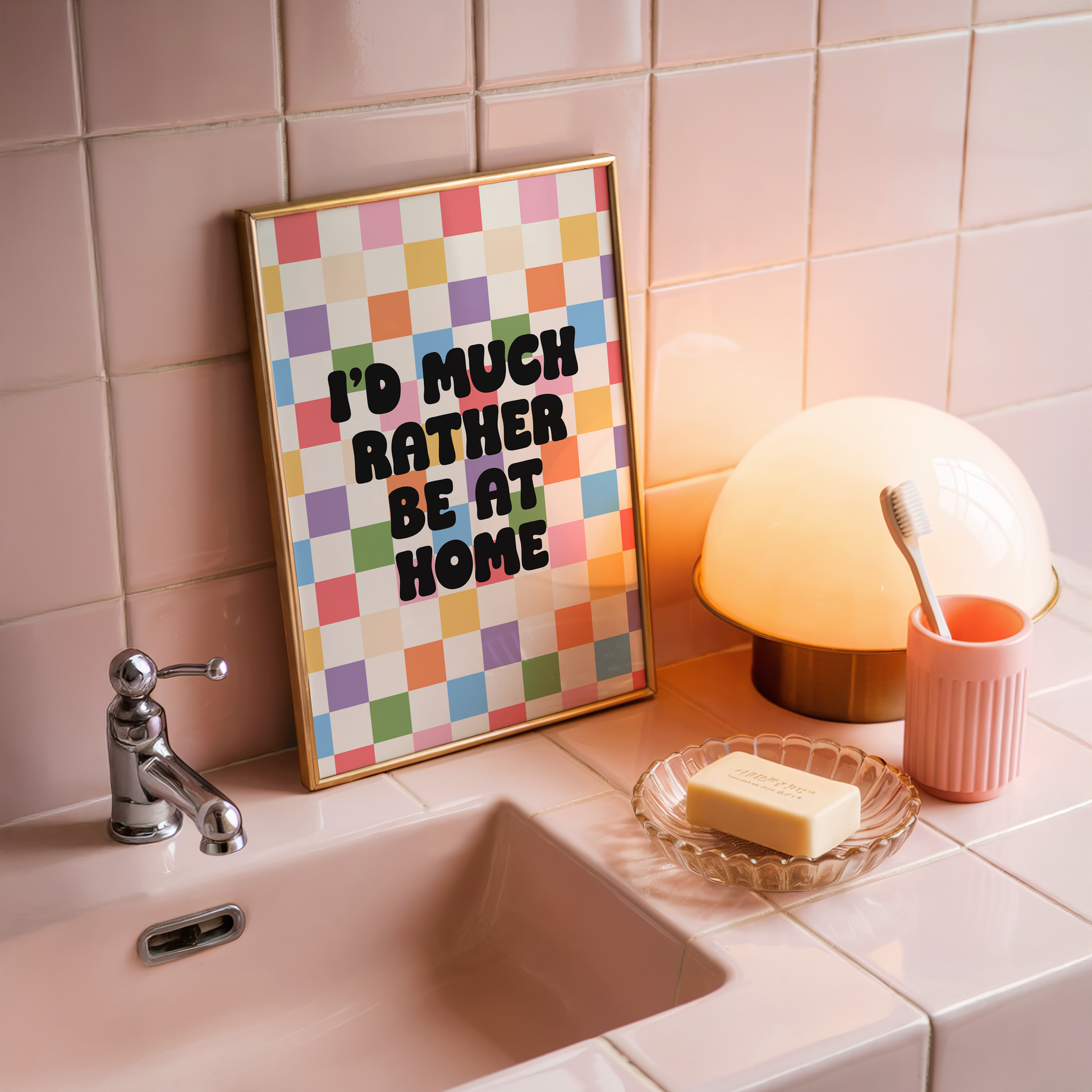 A colourful checkered print with the text 'I'd much rather be at home' centred, set against a white background.