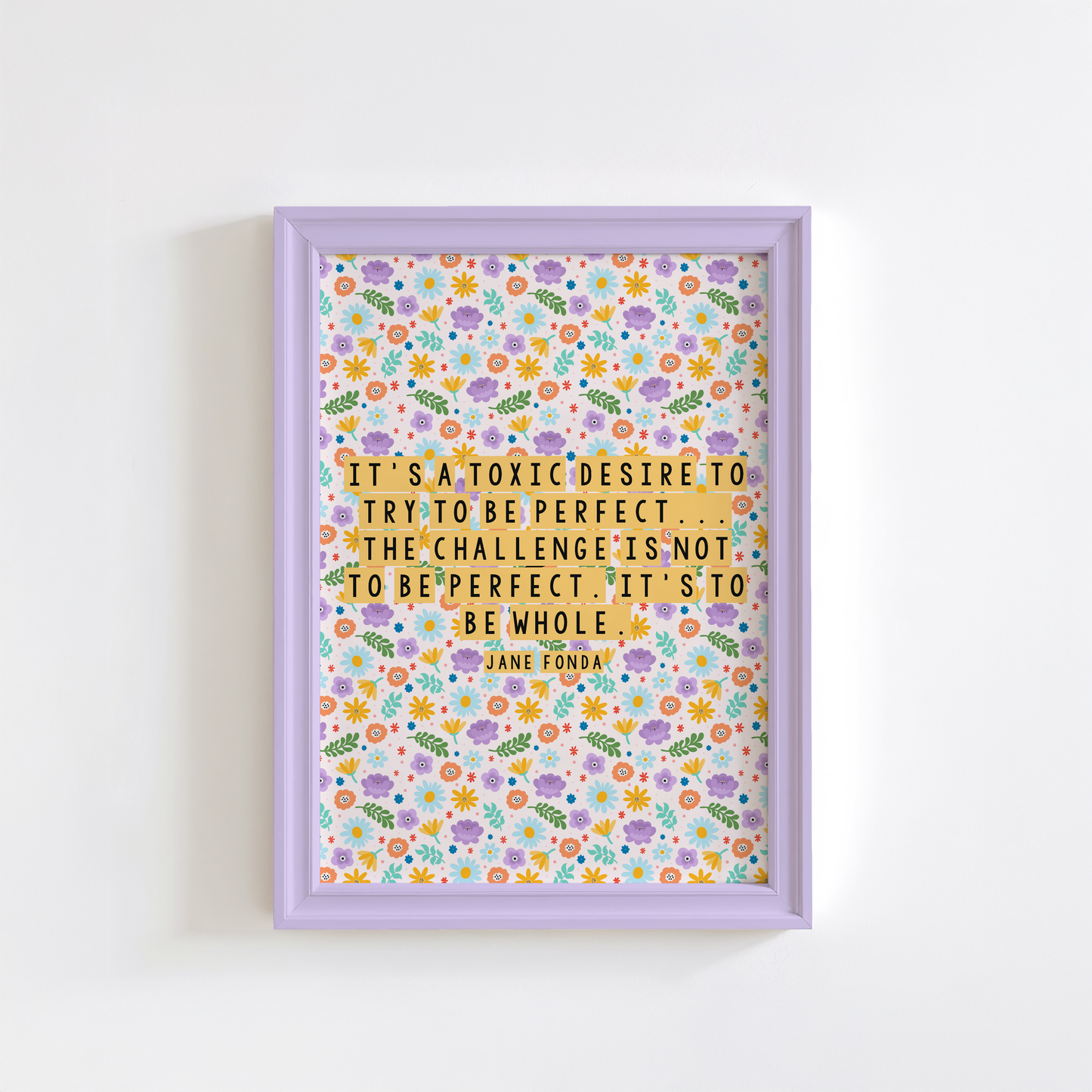 A framed print with a colourful floral pattern background featuring a quote by Jane Fonda.
