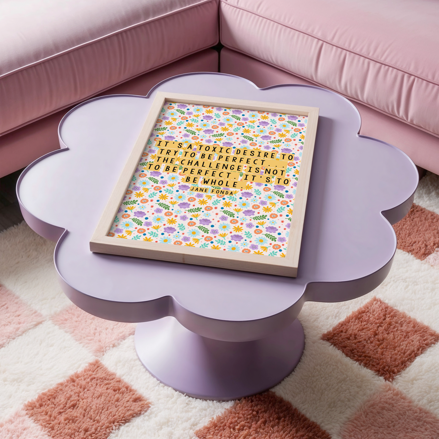 A framed print with a colourful floral pattern background featuring a quote by Jane Fonda.
