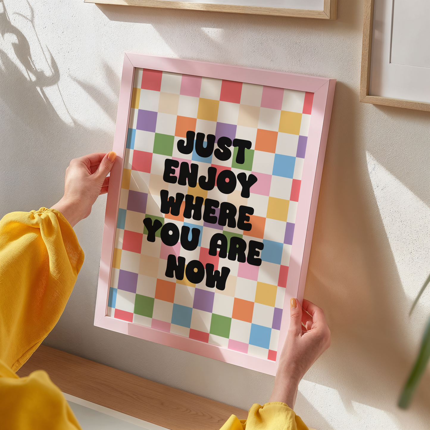 A colourful checkered background, with a quote saying "just enjoy where you are now".