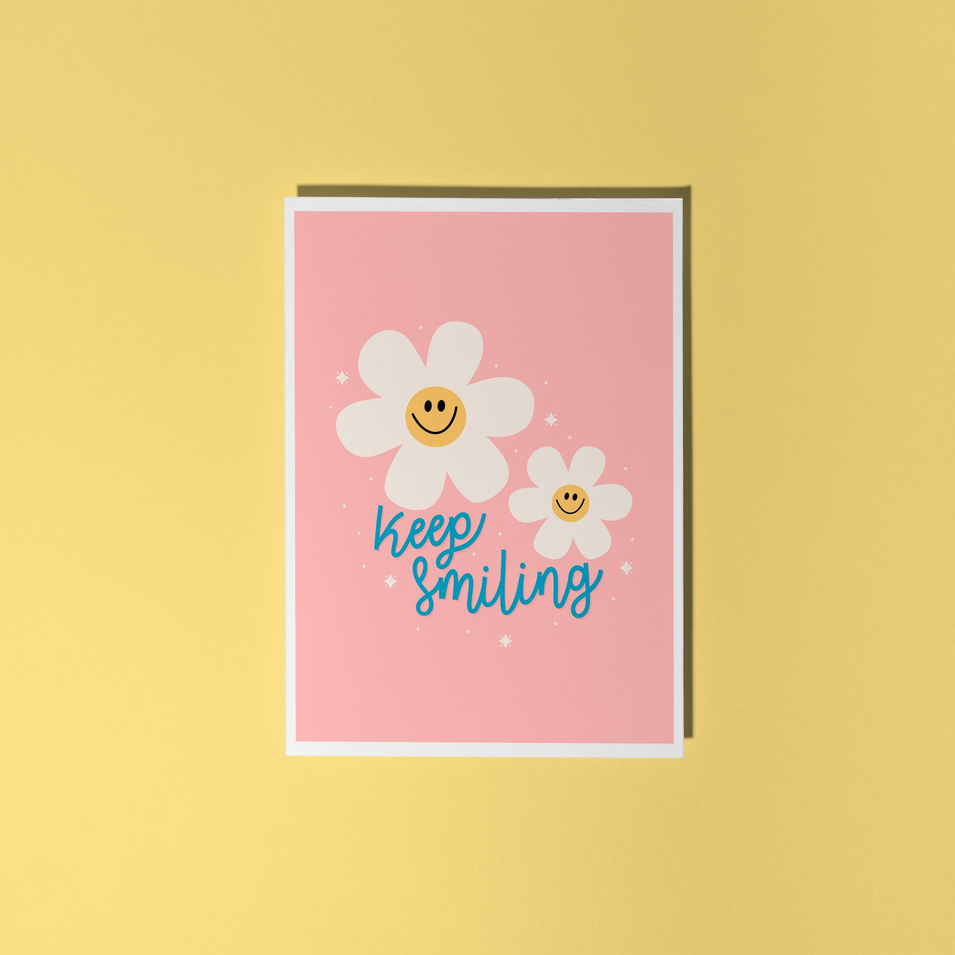 Card with smiley flowers and 'Keep smiling' text on a pink background