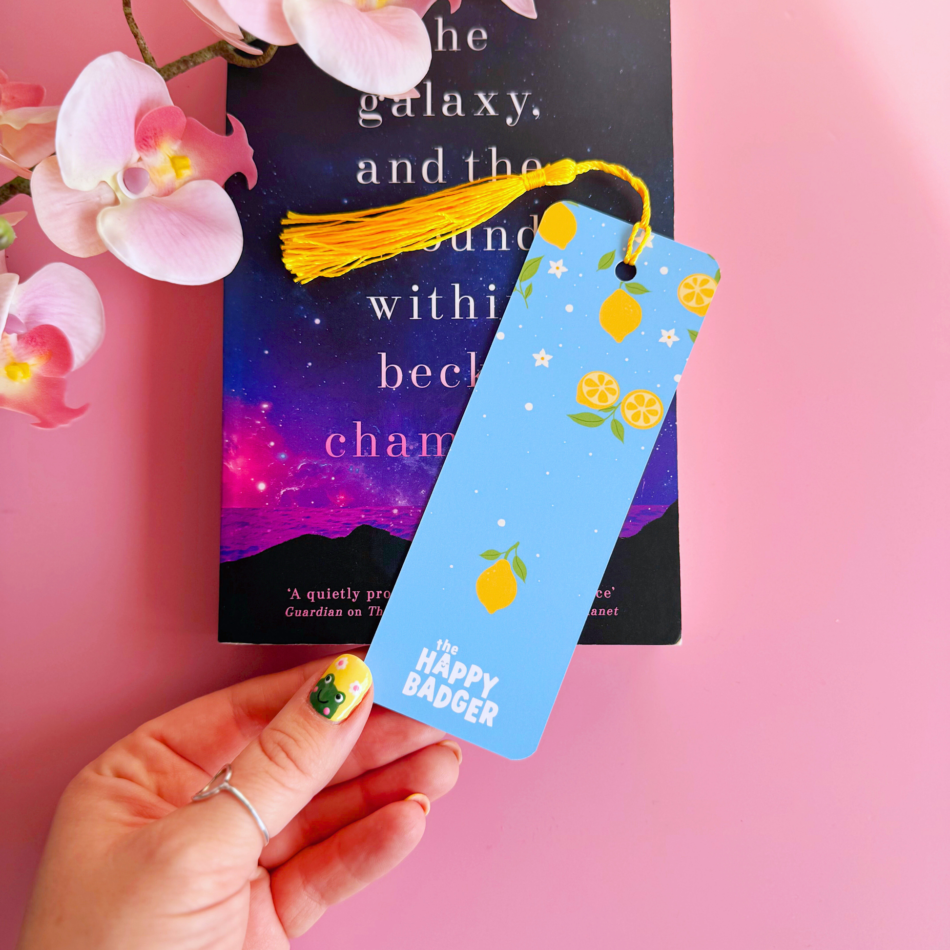 A blue bookmark with a yellow lemon pattern, and a coordinating yellow tassel.