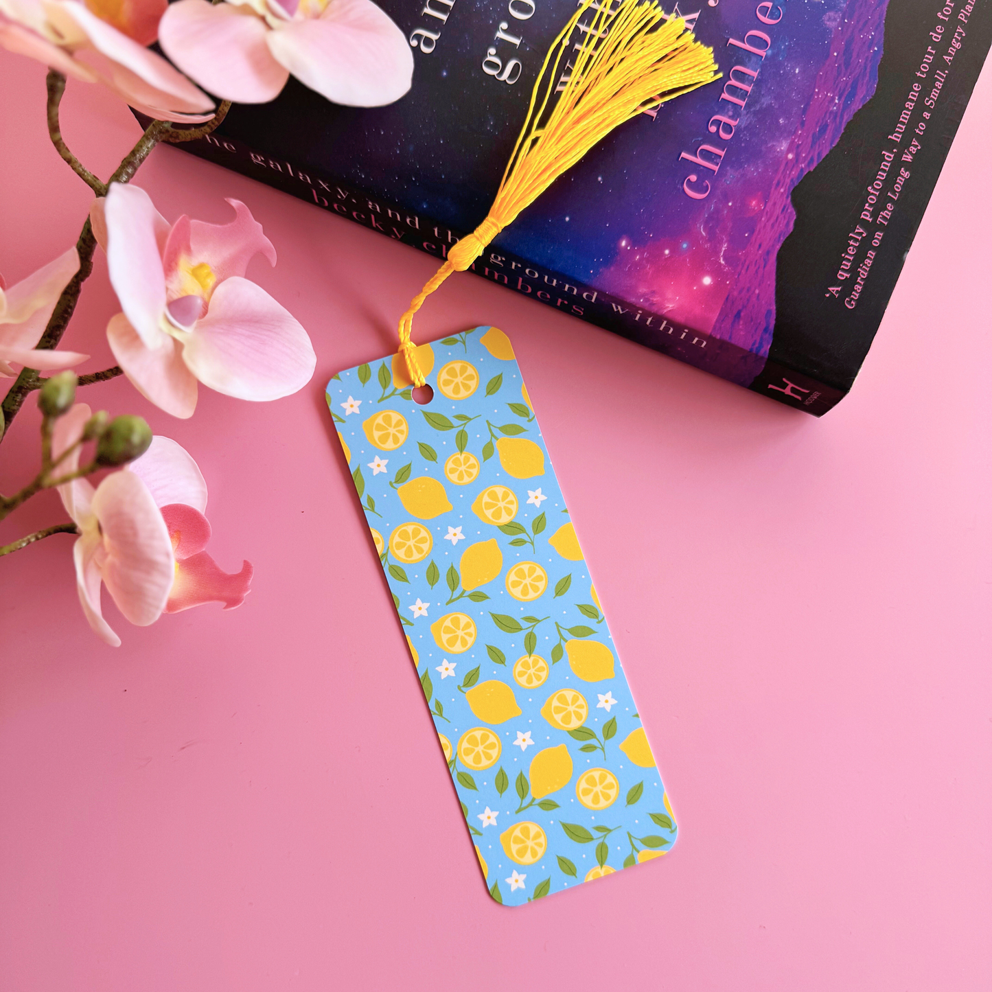 A blue bookmark with a yellow lemon pattern, and a coordinating yellow tassel.
