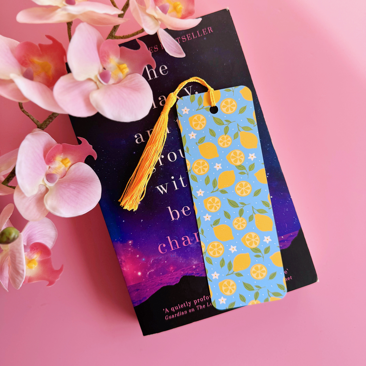 A blue bookmark with a yellow lemon pattern, and a coordinating yellow tassel.