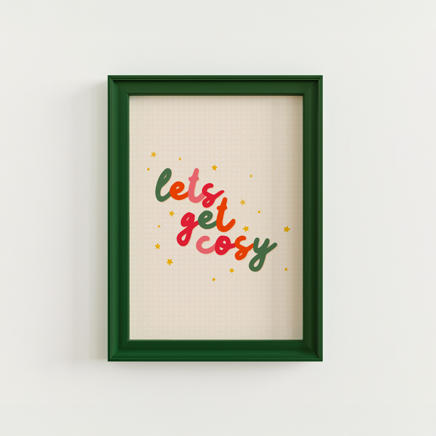 A quote print in autumnal colours that reads 'lets get cosy' in a handwritten font.
