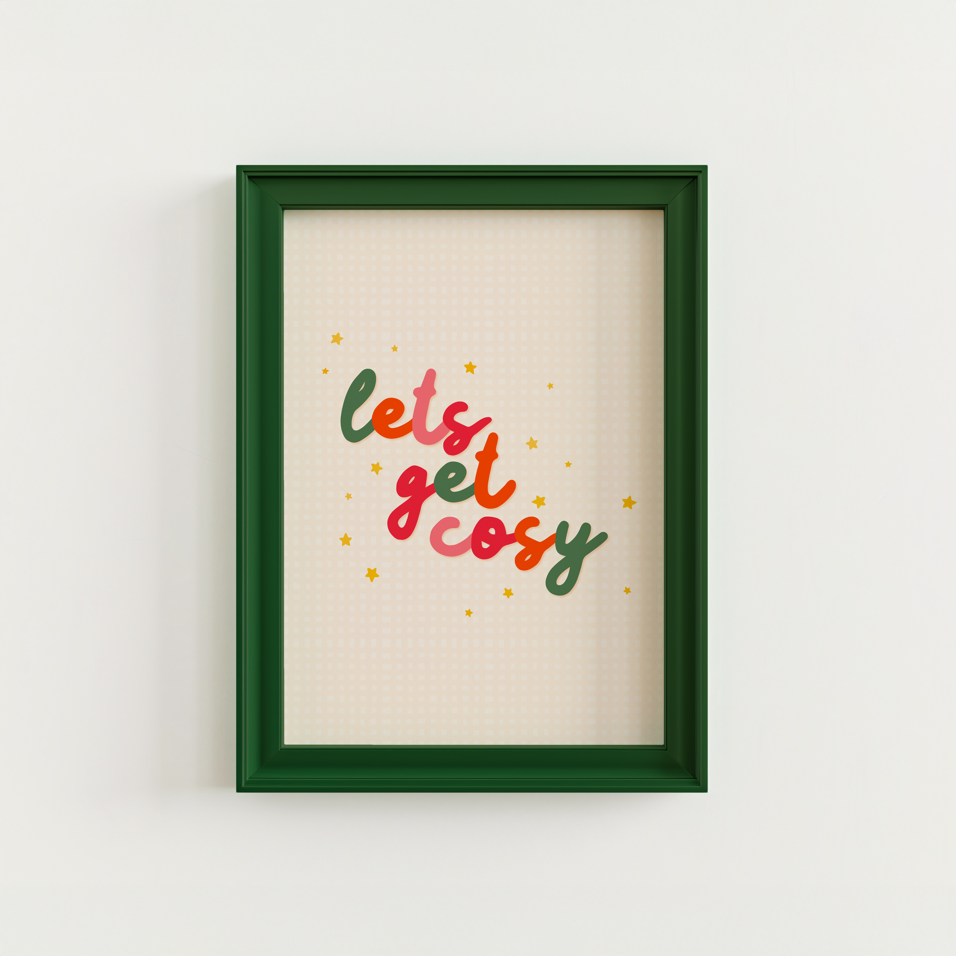 A quote print in autumnal colours that reads 'lets get cosy' in a handwritten font.