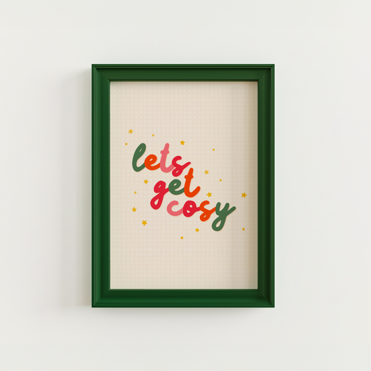 A quote print in autumnal colours that reads 'lets get cosy' in a handwritten font.