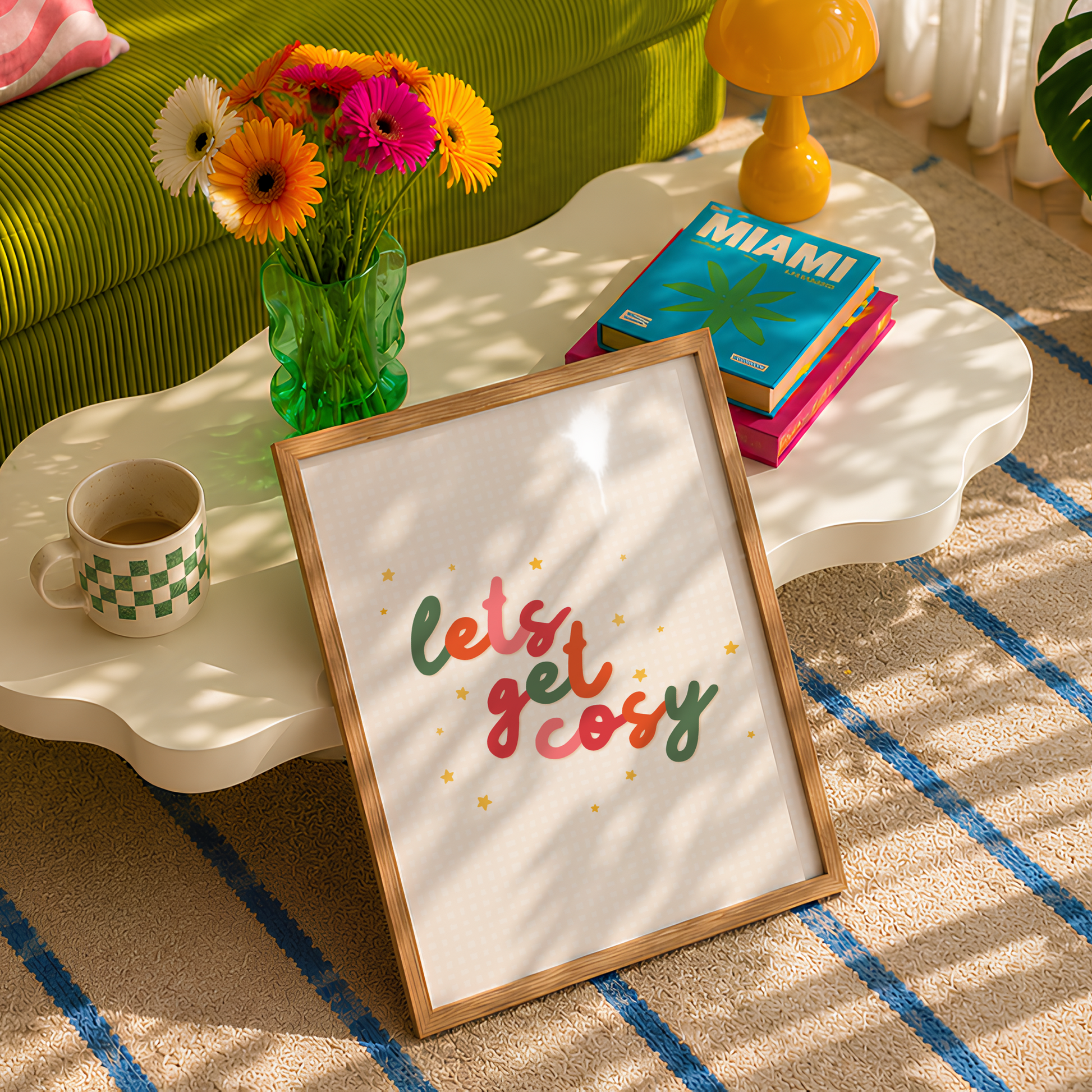 A quote print in autumnal colours that reads 'lets get cosy' in a handwritten font.