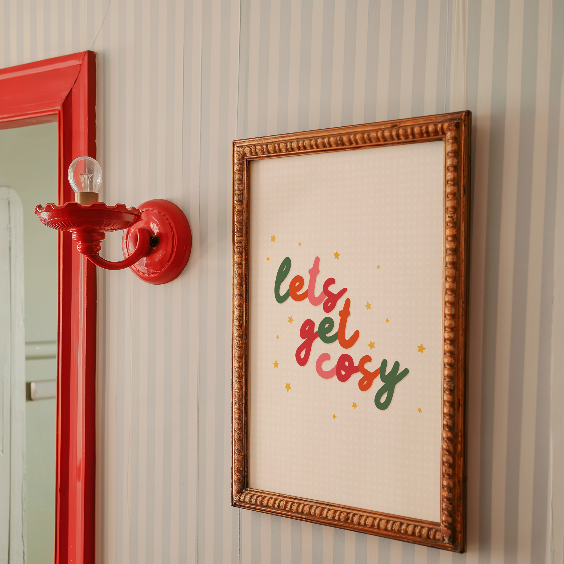 A quote print in autumnal colours that reads 'lets get cosy' in a handwritten font.