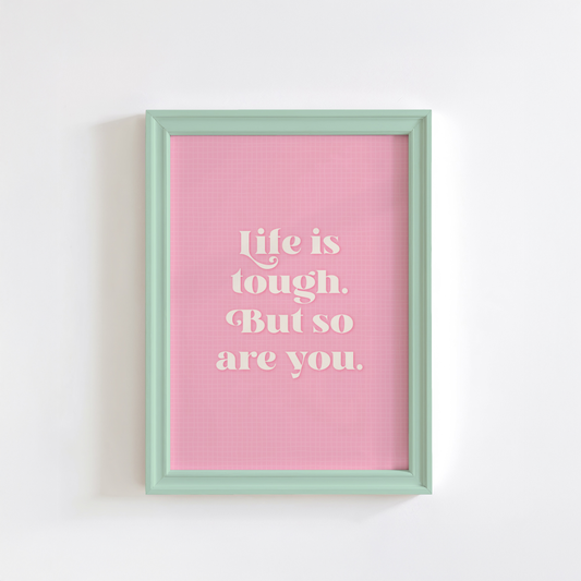 A pink print with a soft check pattern, and a quote in white that reads 'life is tough. But so are you.'.