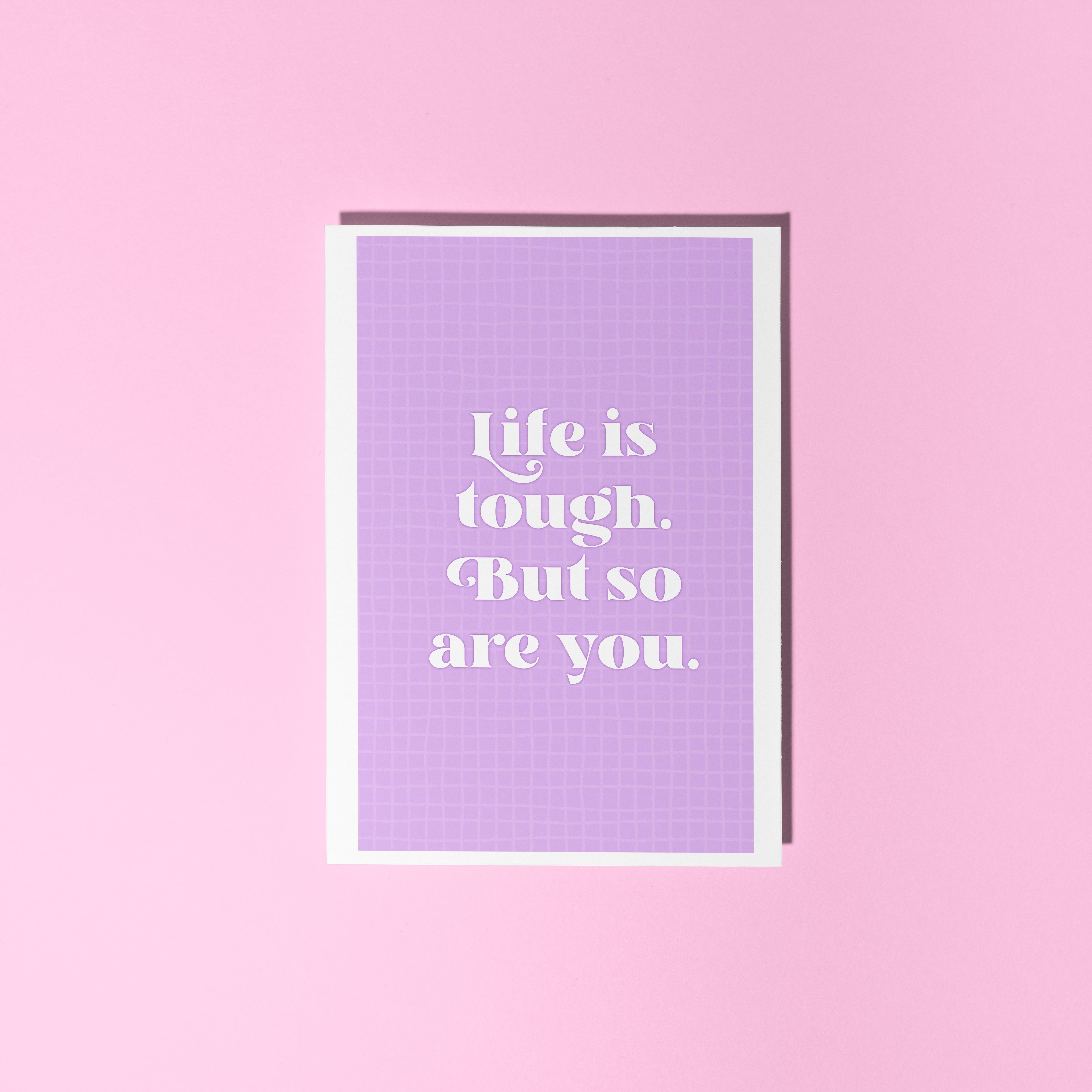 A purple card, with the quote 'life is tough, but so are you' on the front.