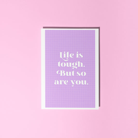 A purple card, with the quote 'life is tough, but so are you' on the front.
