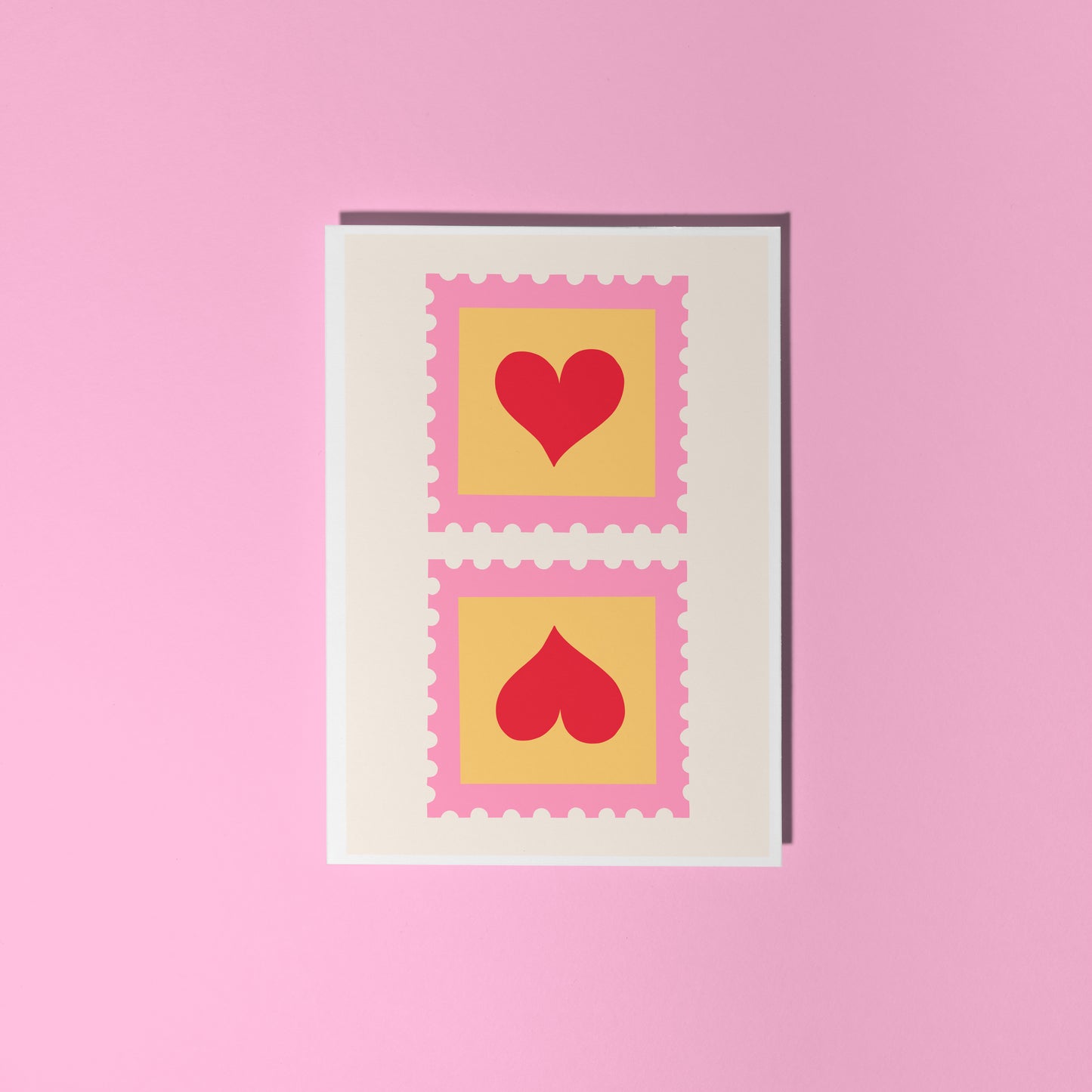 An illustrated card with two love heart postage stamps on the front, in pink, yellow and red.
