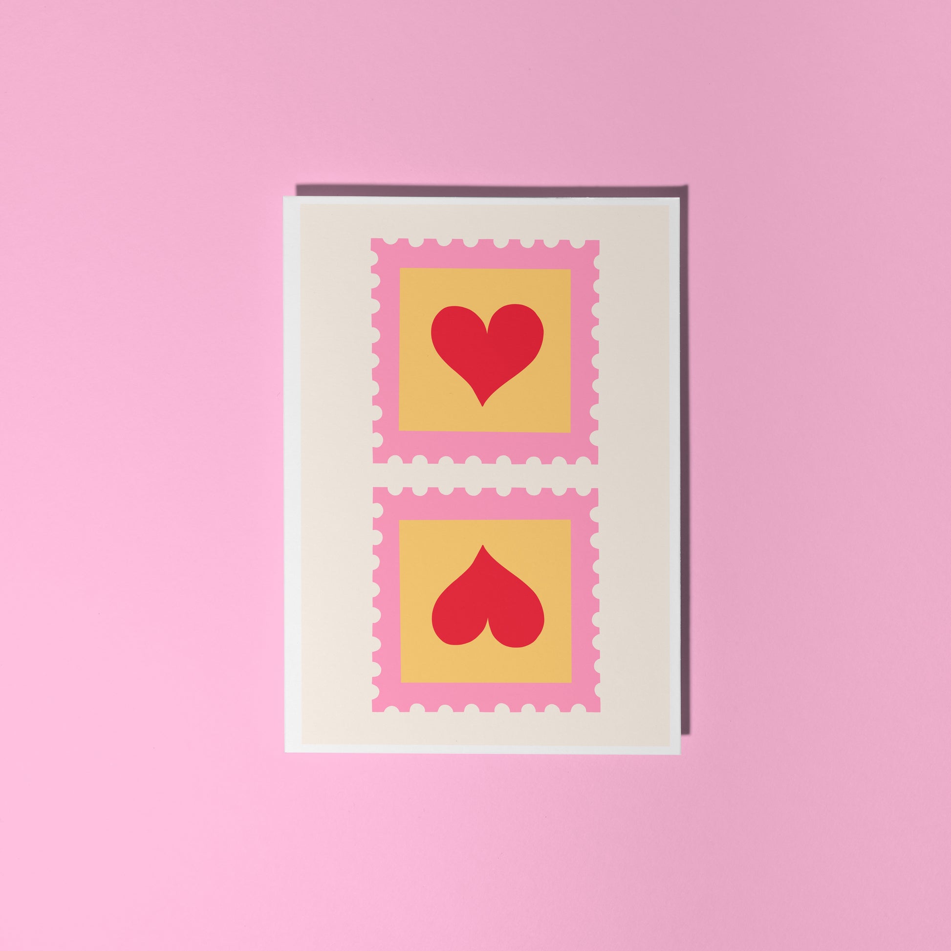 An illustrated card with two love heart postage stamps on the front, in pink, yellow and red.