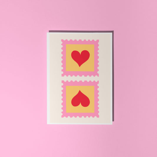 An illustrated card with two love heart postage stamps on the front, in pink, yellow and red.