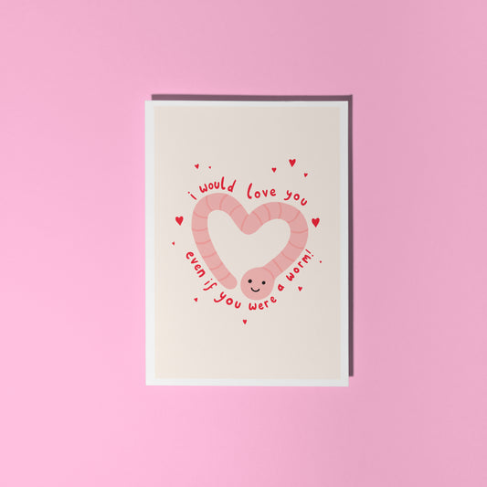An illustrated card with a drawing of a cute smiling worm on the front, in the shape of a heart. Around the worm is text that reads 'I would love you even if you were a worm!'.