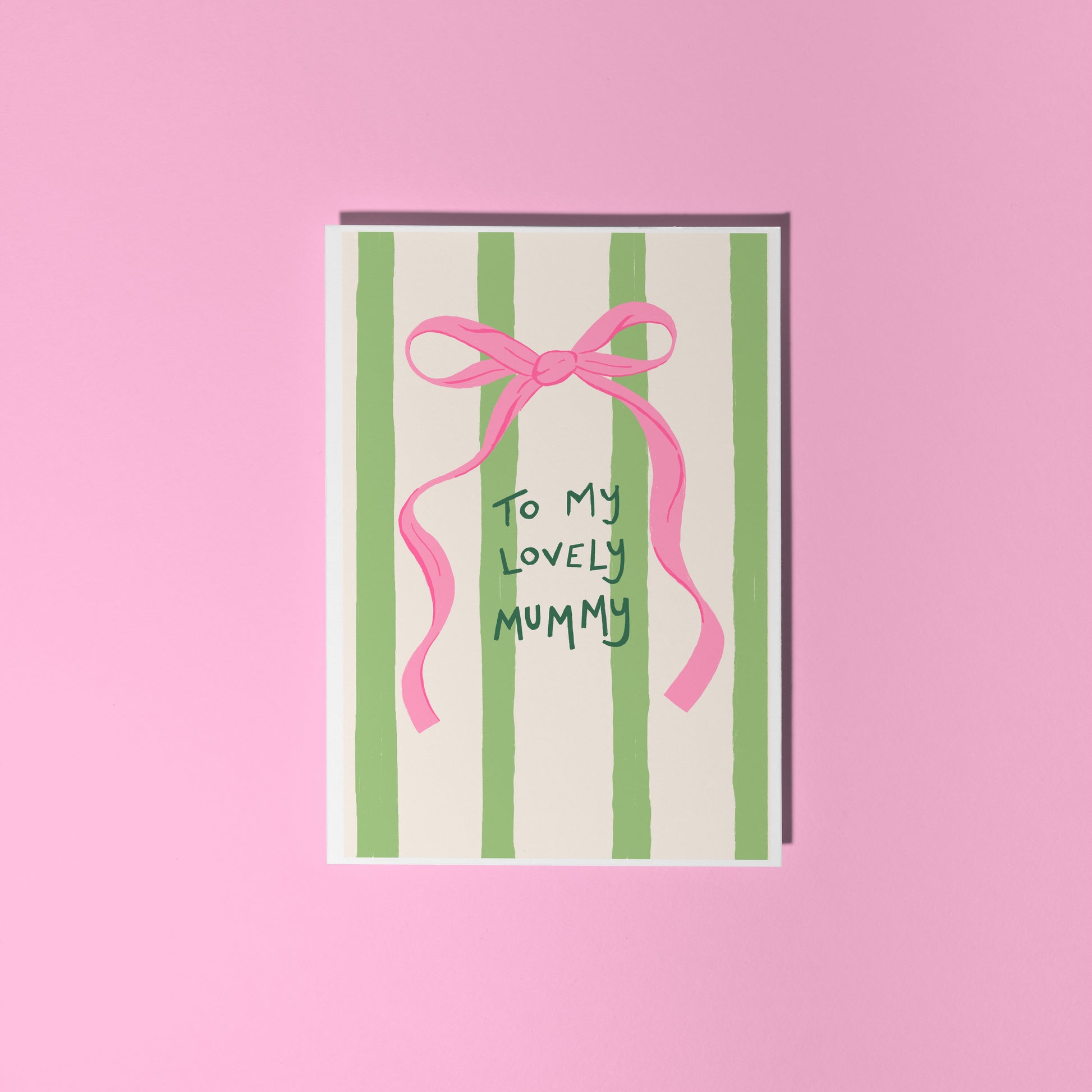 A cream and green striped card, with a pink bow, and handwritten text that says 'to my lovely mummy'.