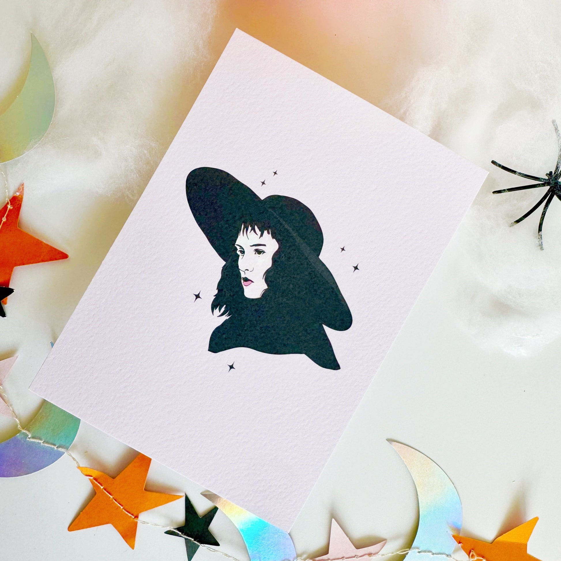 A halloween themed textured postcard with an illustration of Lydia Deetz, from Beetlejuice on the front.