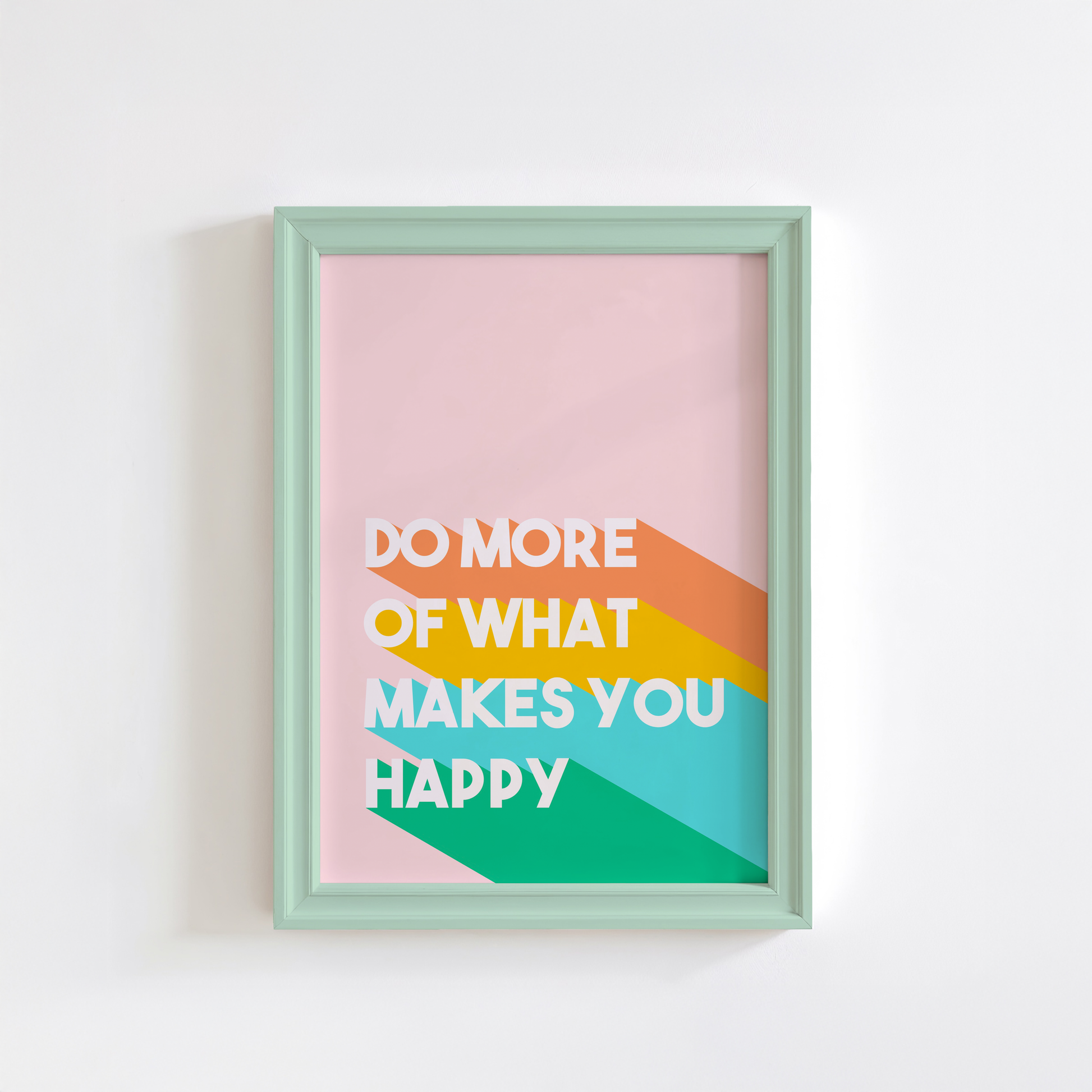 A motivational quote print in orange, yellow blue and green, saying do more of what makes you happy.