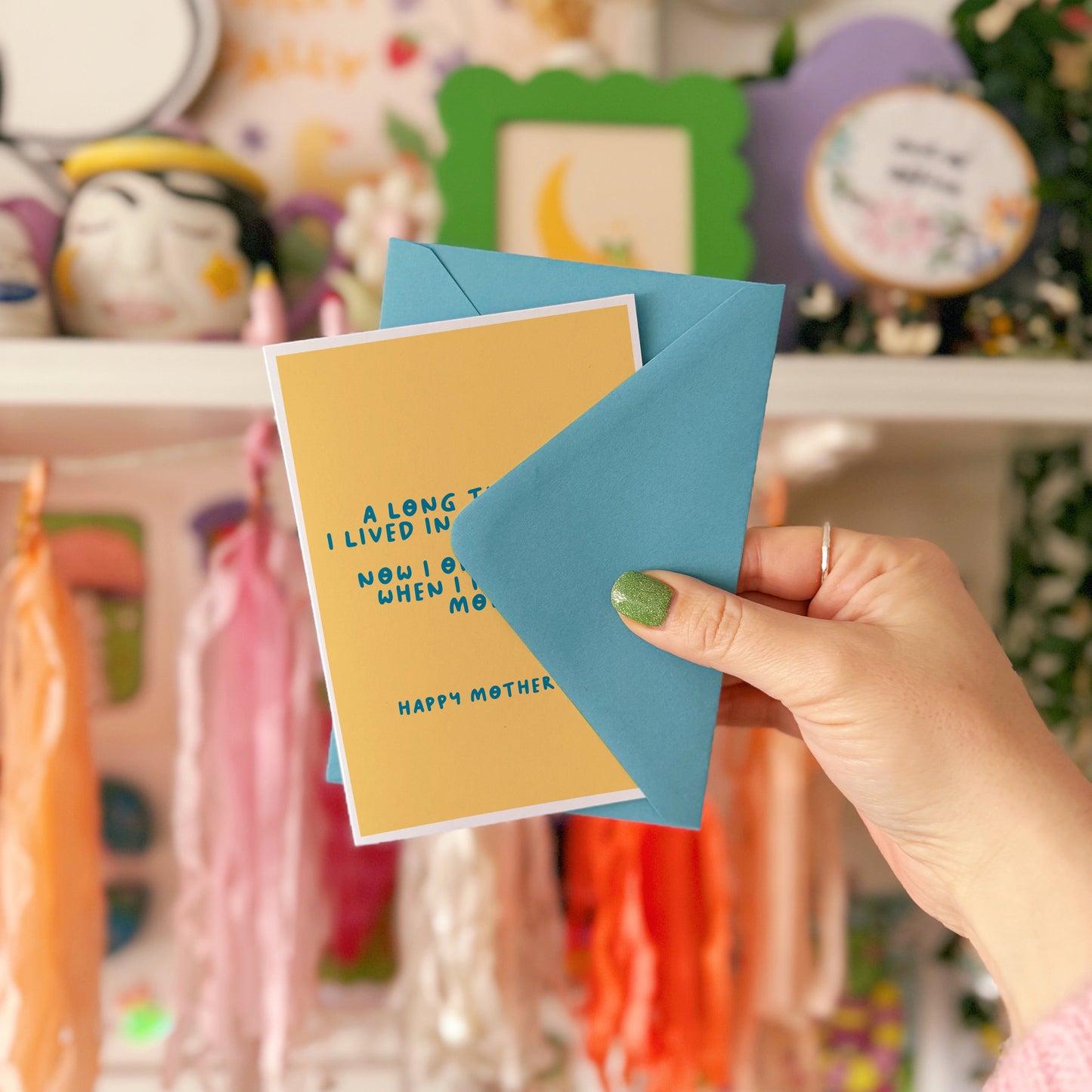 A yellow Mother's Day card with a funny quote, that says 'A long time ago I lived in your tummy. Now I only see you, when I need some money. Happy Mother's Day".