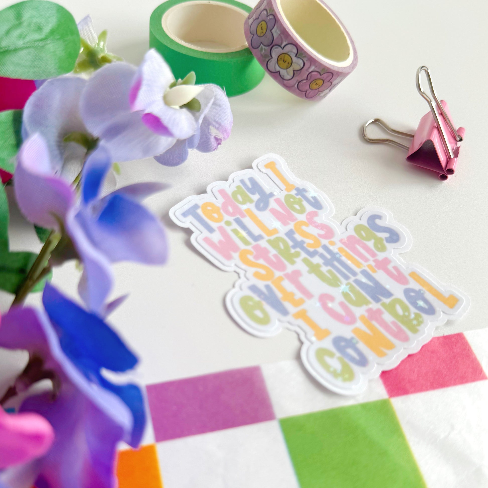 A holographic sticker, with the quote today I will not stress over things I can't control on it. The sticker has an easy peel lip.