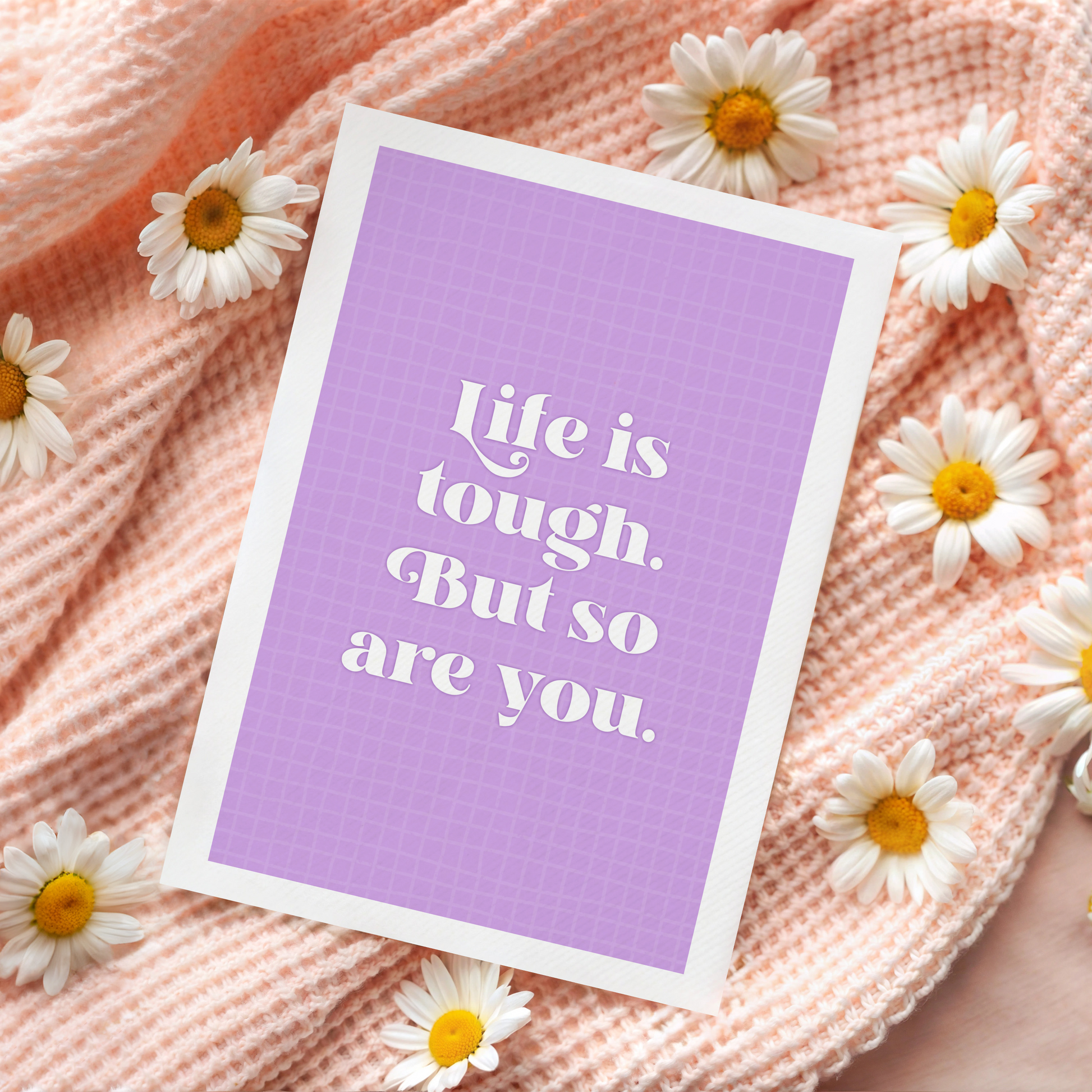 A purple card, with the quote 'life is tough, but so are you' on the front.