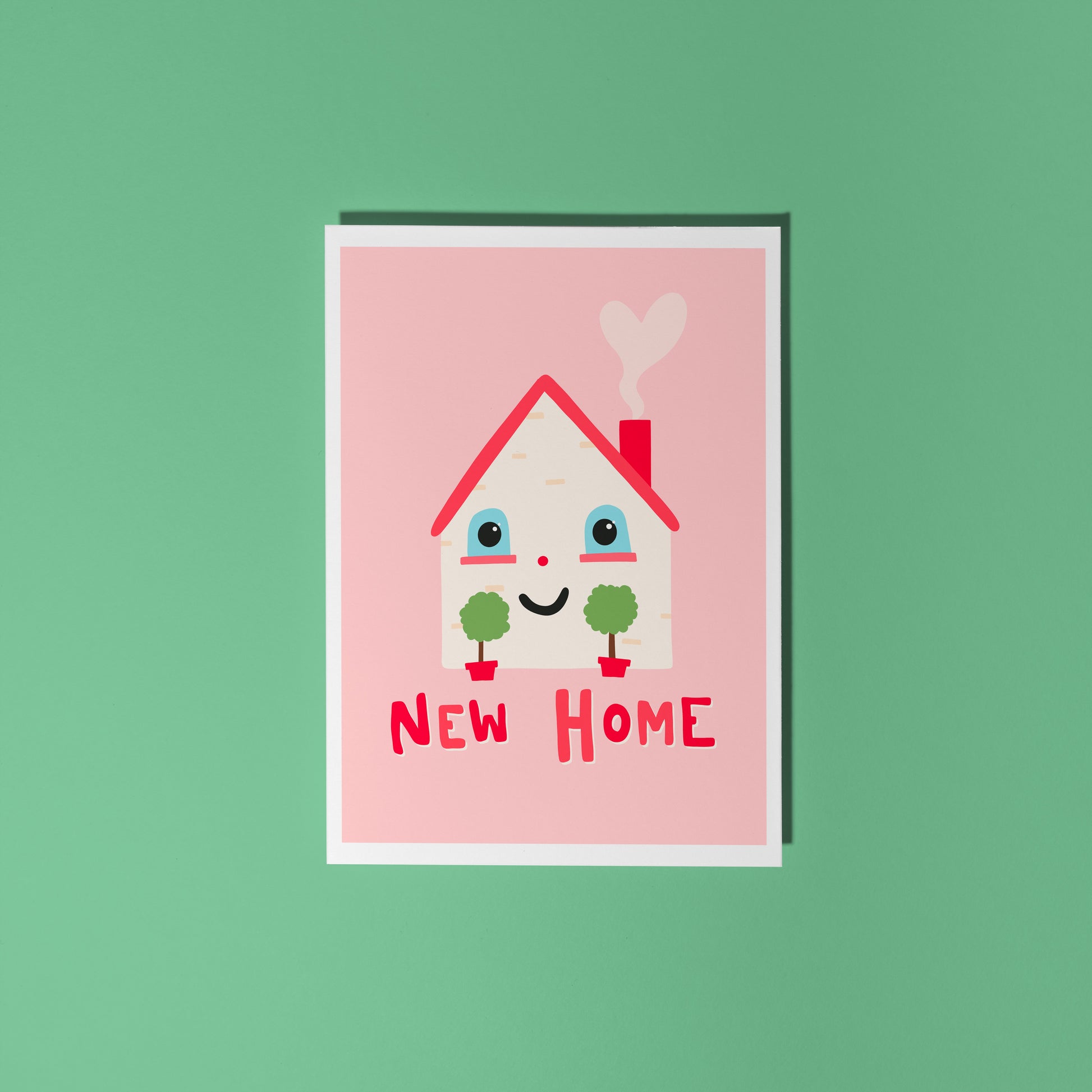 A new home congratulations card with an illustration of a little house with a smiling face and hand lettering underneath that reads 'New Home'.