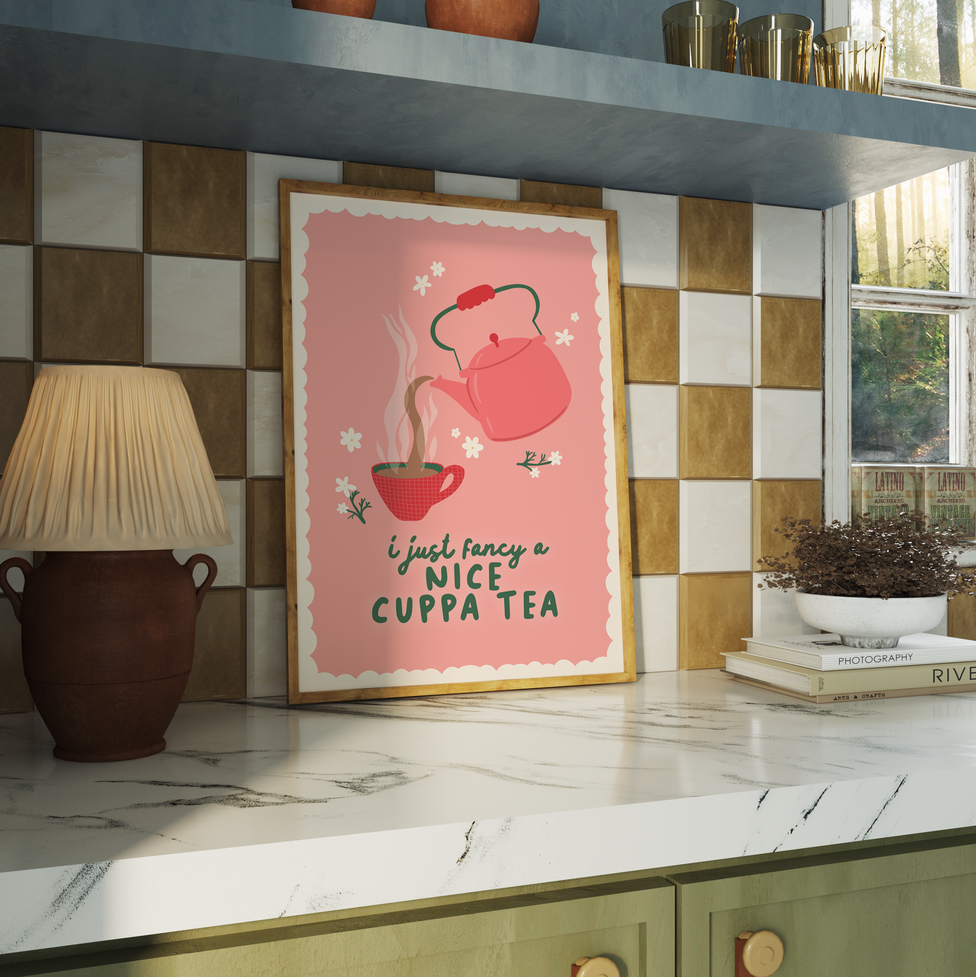 A pink print with a scalloped edge border, with a teapot and mug illustration and a cosy quote.