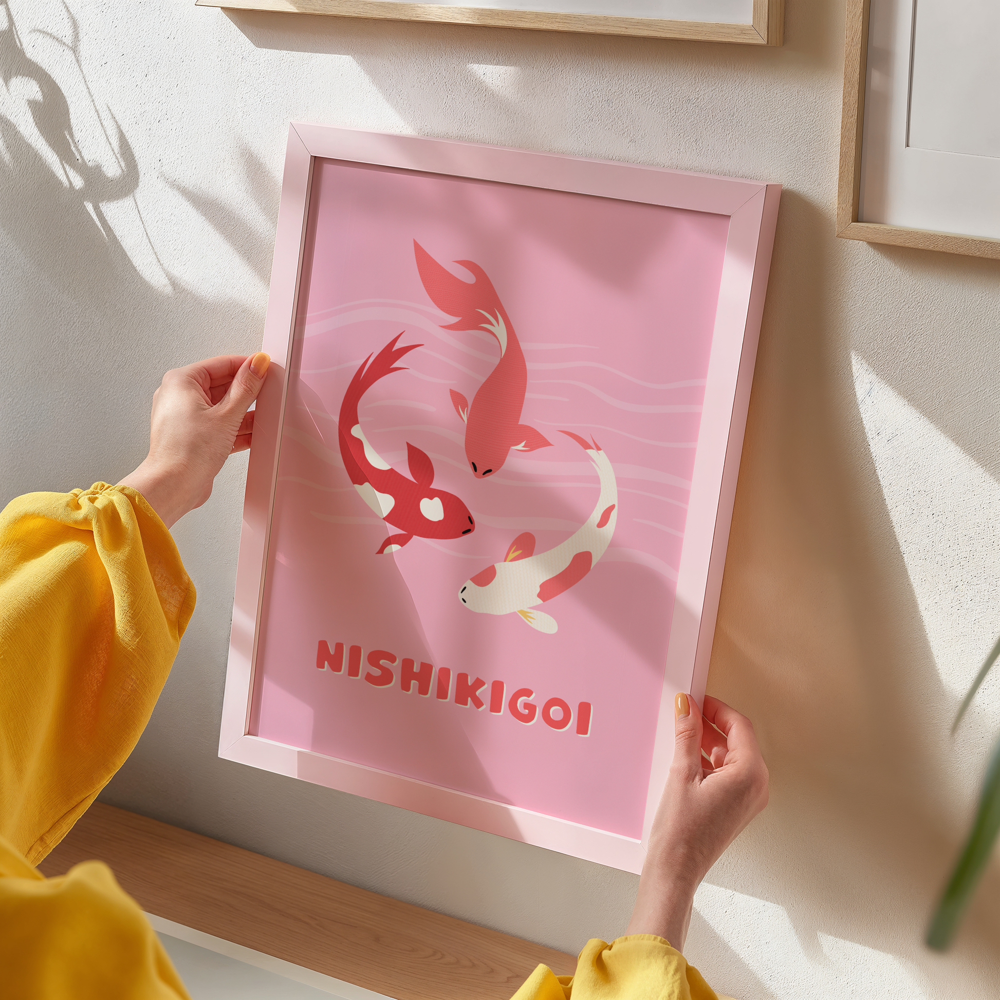 A pink print with an illustration of three Nishikigoi or Japanese carp fish. 