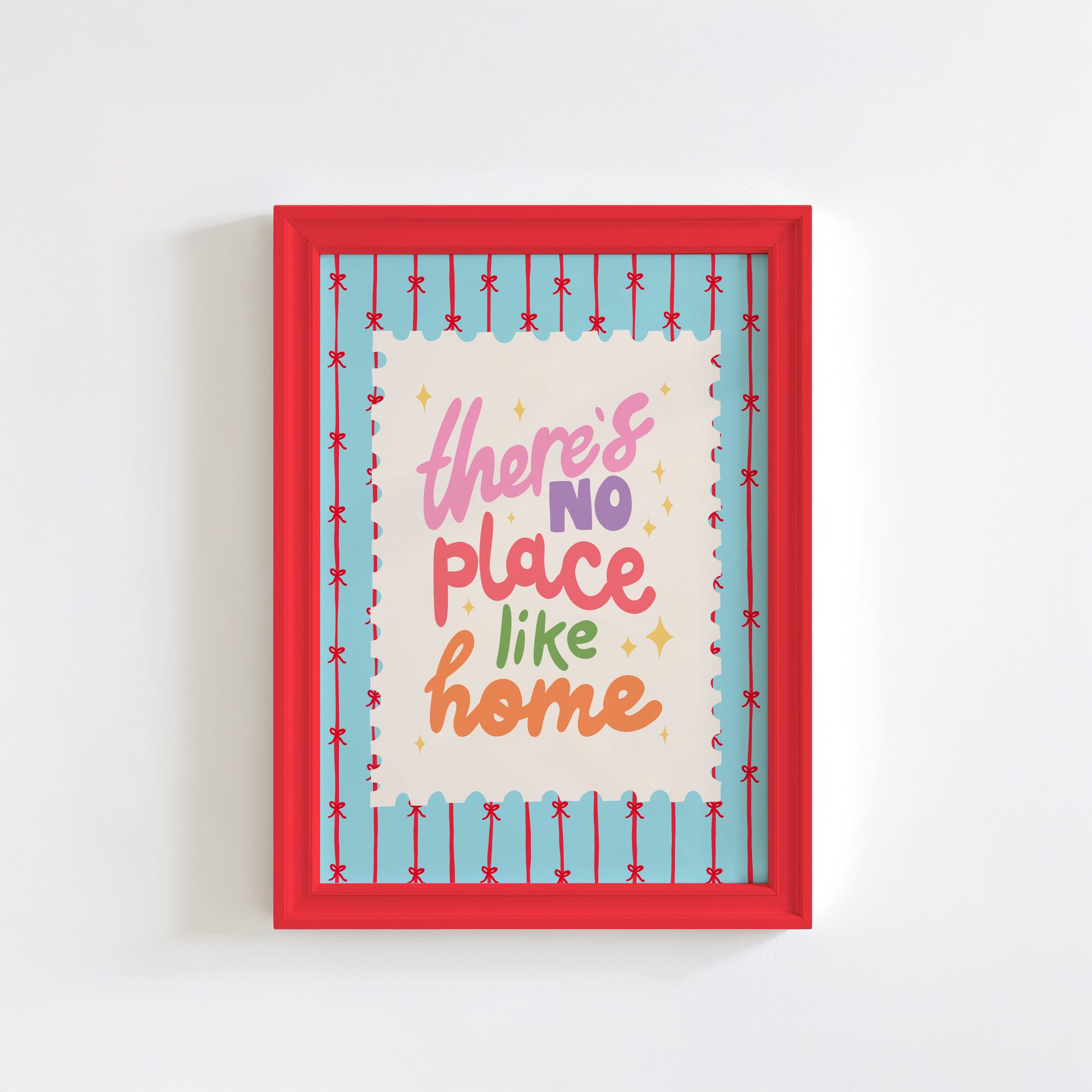 A blue print with red stripes and bows across it, in the centre is a postage-stamp style border with hand lettered text that reads 'there's no place like home'.