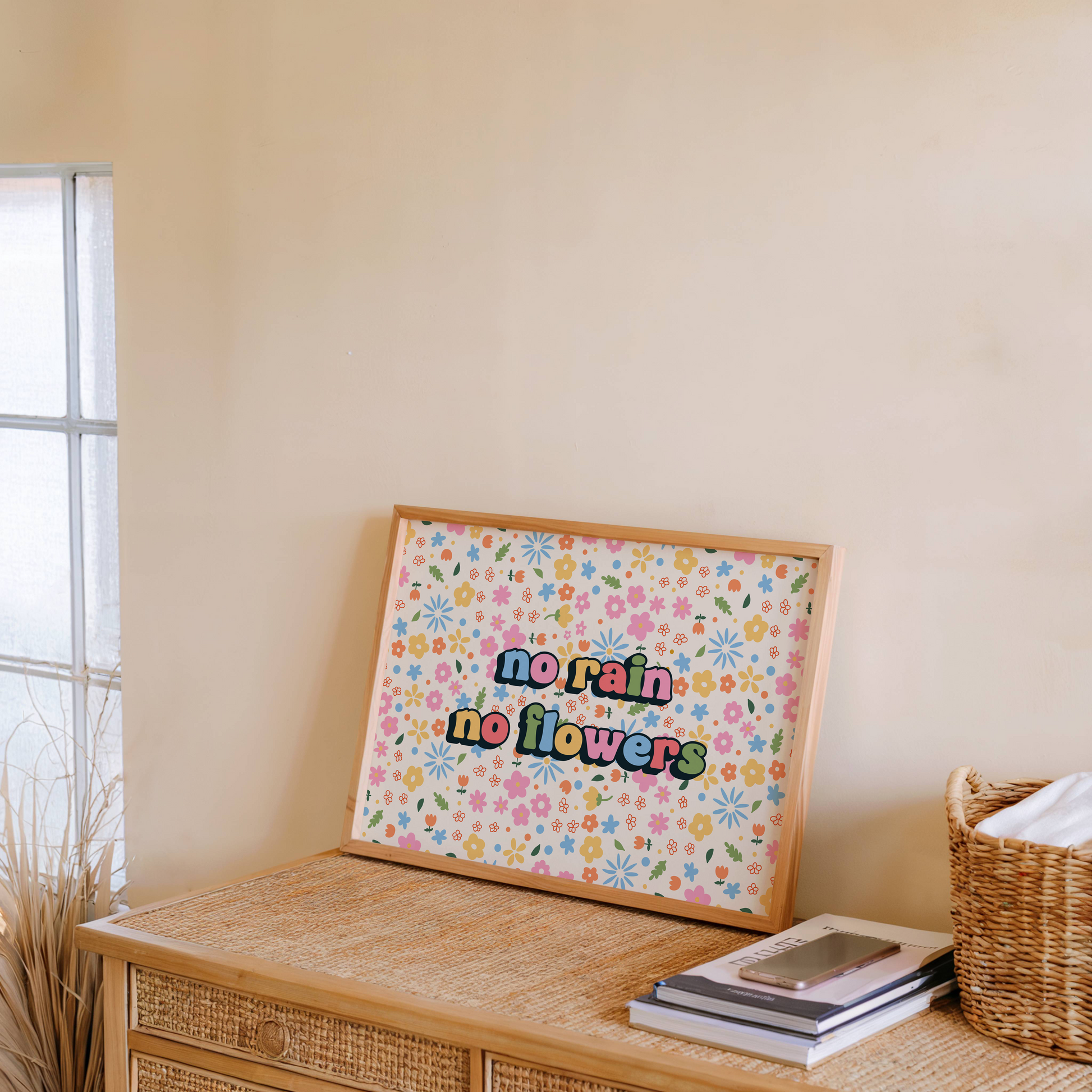 A colourful floral patterned print, with bright multi coloured text that reads 'no rain no flowers' in the centre.