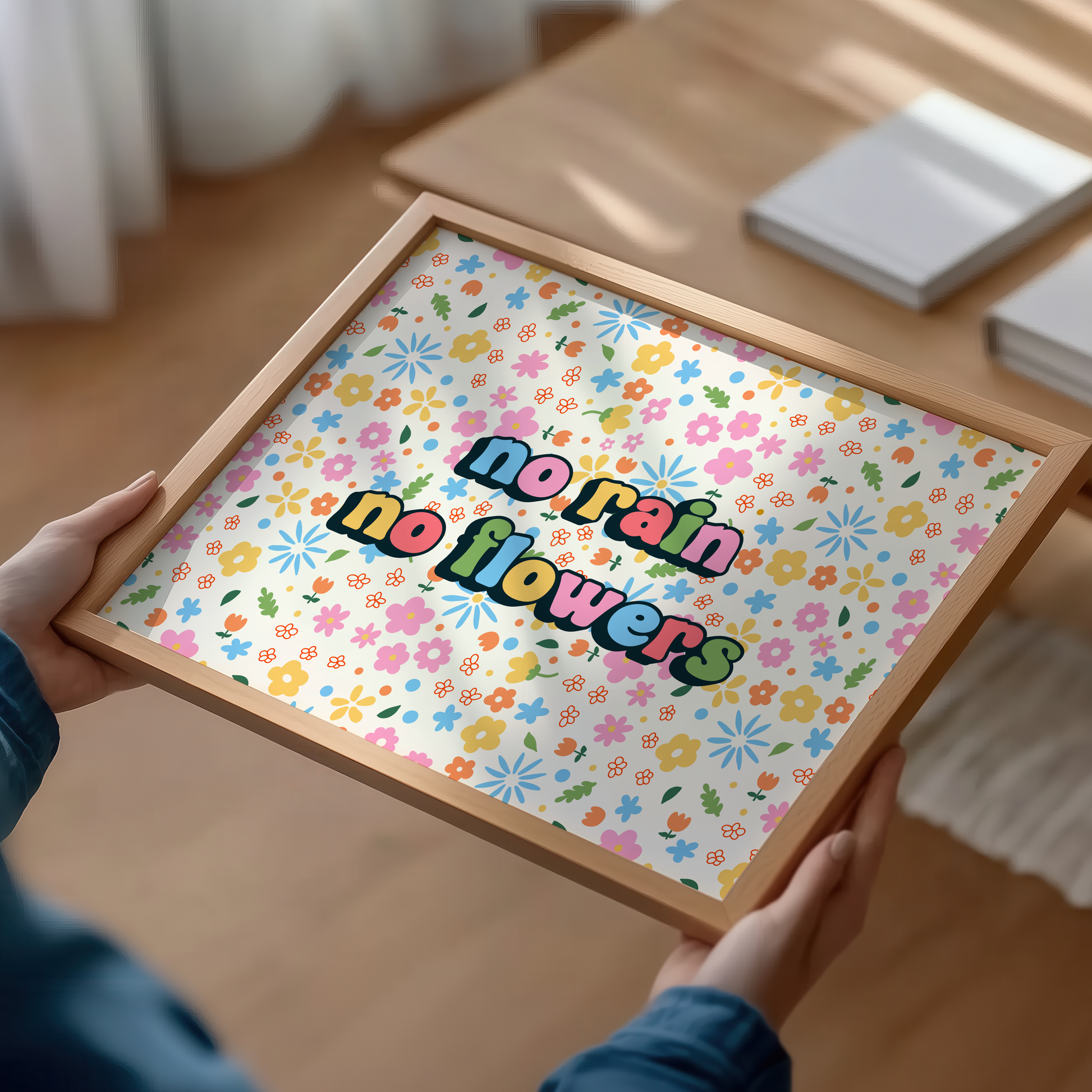 A colourful floral patterned print, with bright multi coloured text that reads 'no rain no flowers' in the centre.