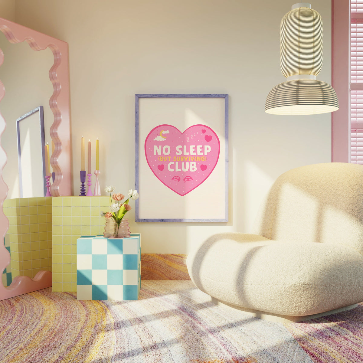 A print with a pink heart, with the words 'No Sleep (but surviving) club' in the centre, with small sleep related doodles around the text.
