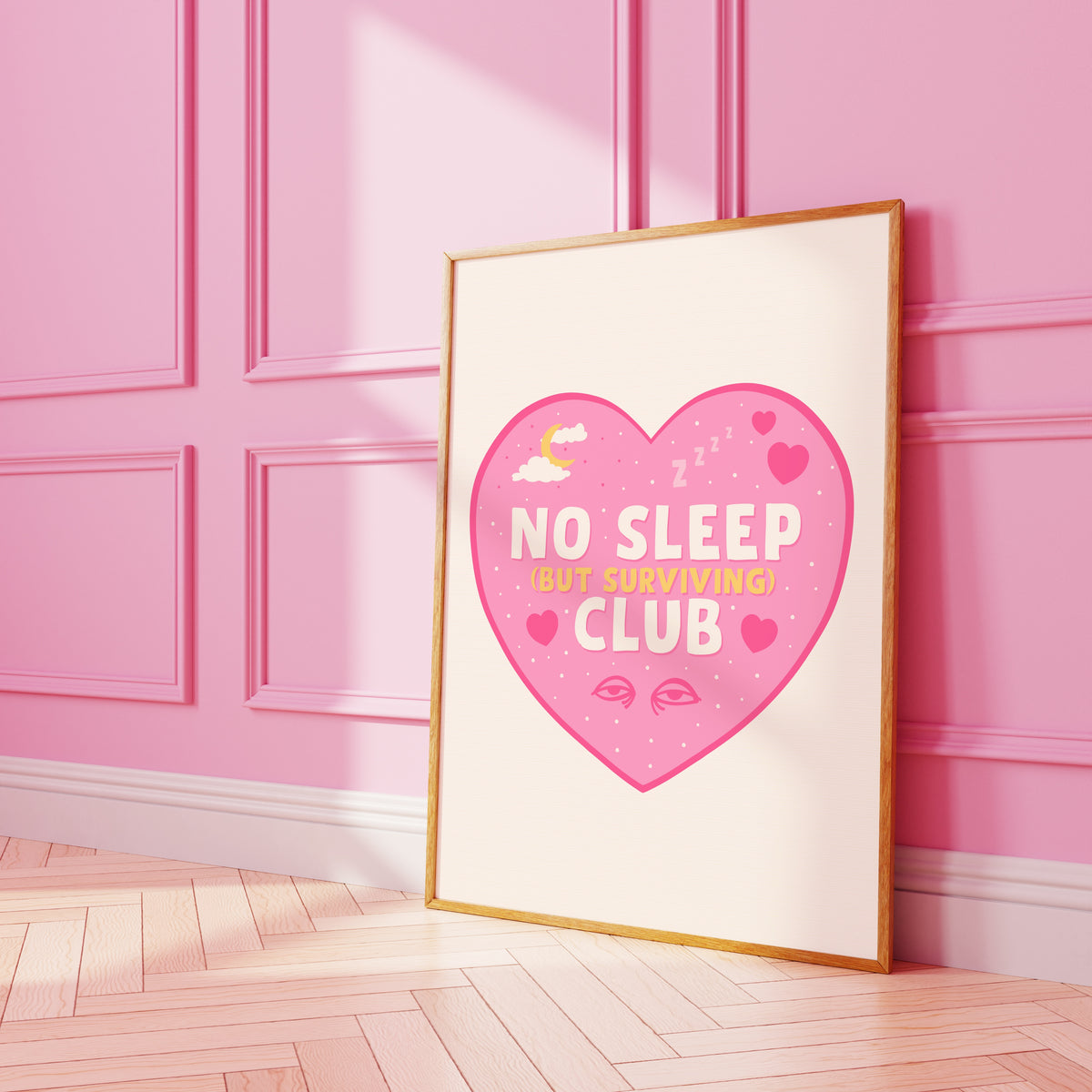 A print with a pink heart, with the words 'No Sleep (but surviving) club' in the centre, with small sleep related doodles around the text.