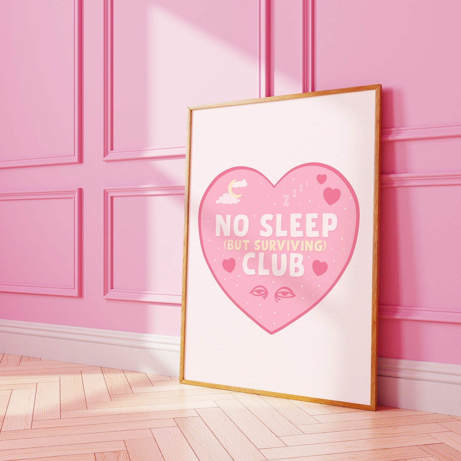 A print with a pink heart, with the words 'No Sleep (but surviving) club' in the centre, with small sleep related doodles around the text.