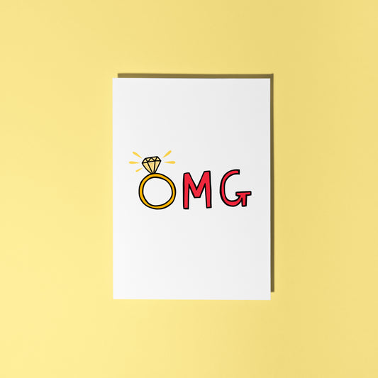 A greetings card that says OMG in hand drawn lettering, with the O as an engagement ring.