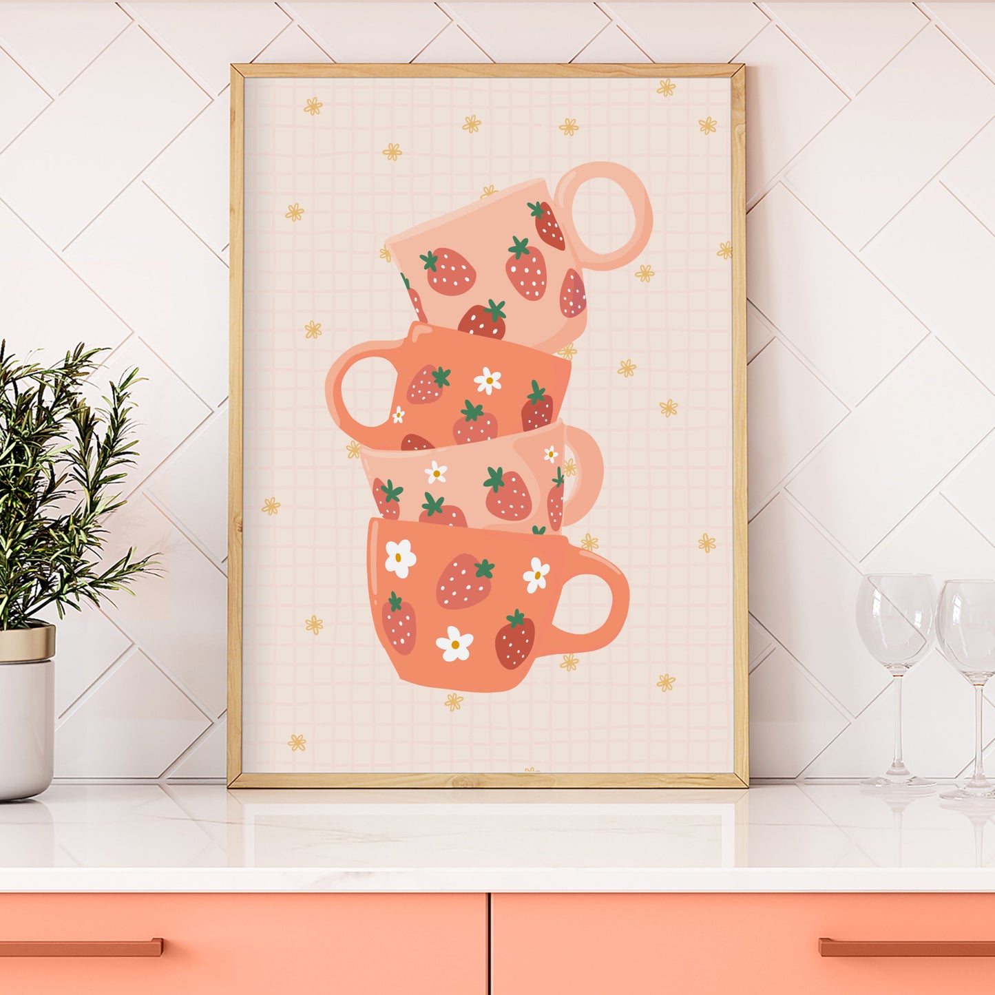 A stack of pink and orange mugs with strawberries on them, on a warm pale orange background.